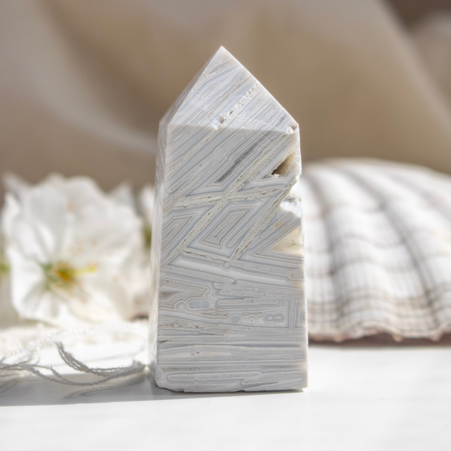 Decorative stone block with geometric patterns on a neutral background