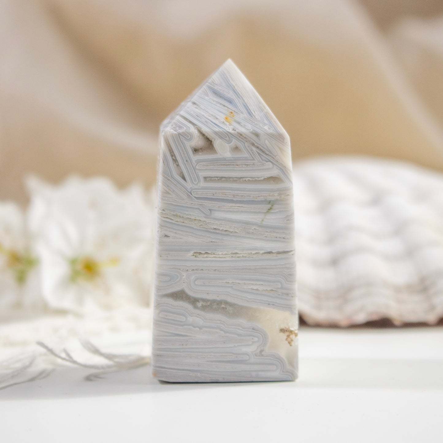 Marble-like tower sculpture on a neutral background