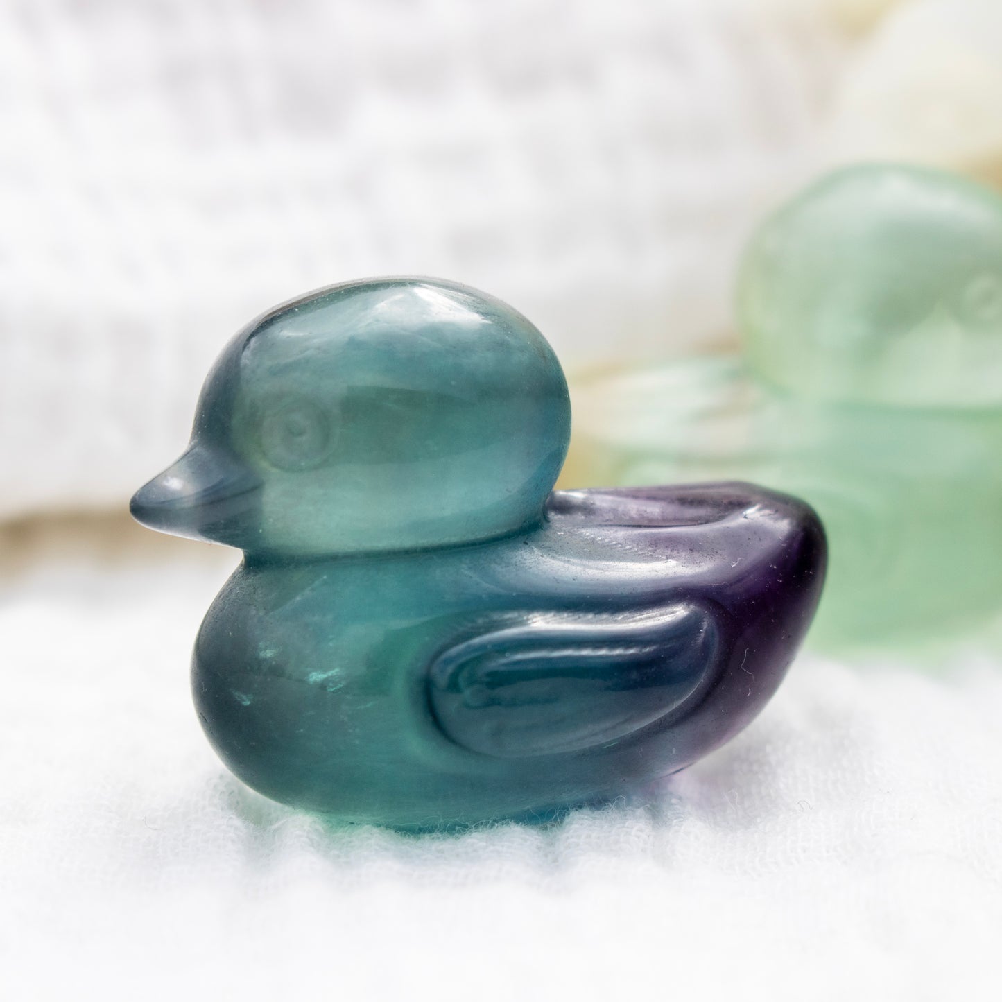 Green fluorite duck-shaped object on a white background