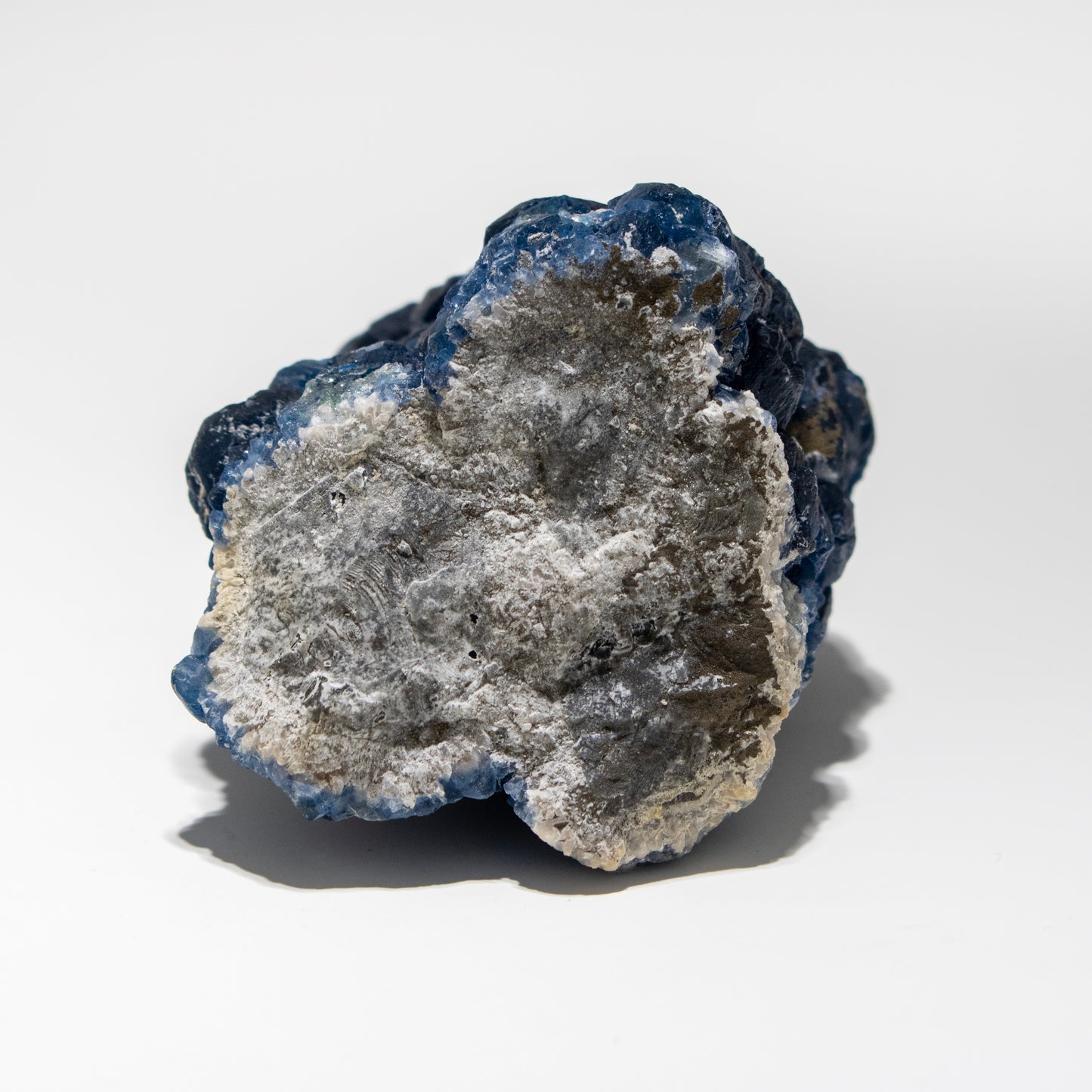 Mineral sample with blue and gray coloration on a white background