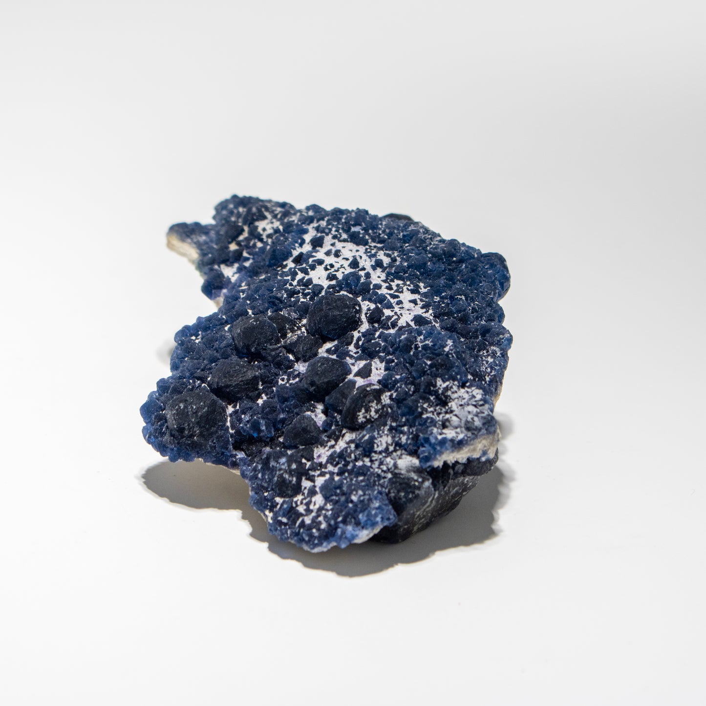 Blue and white mineral specimen on a white background
