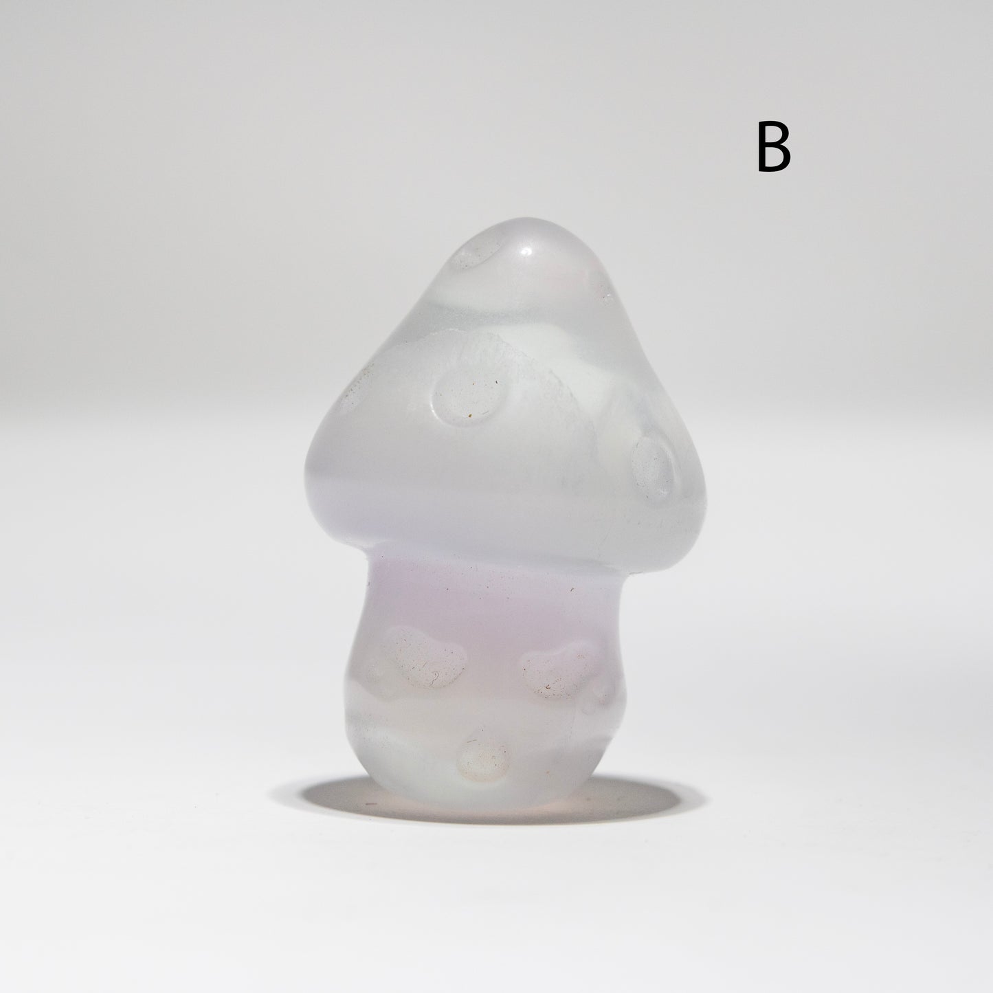 White fluorite mushroom-shaped object on a light gray background