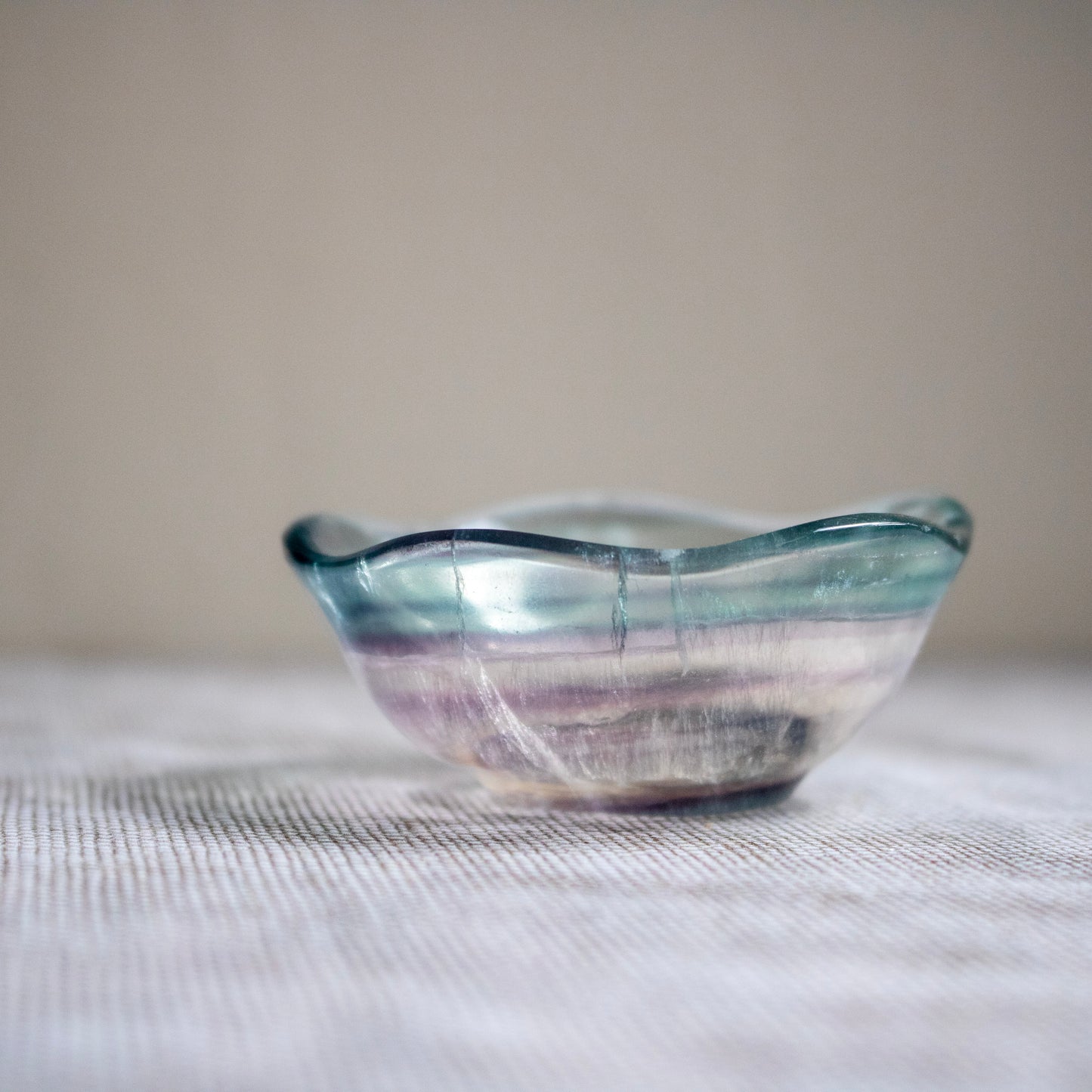 Crystal bowl with wavy design on a textured surface