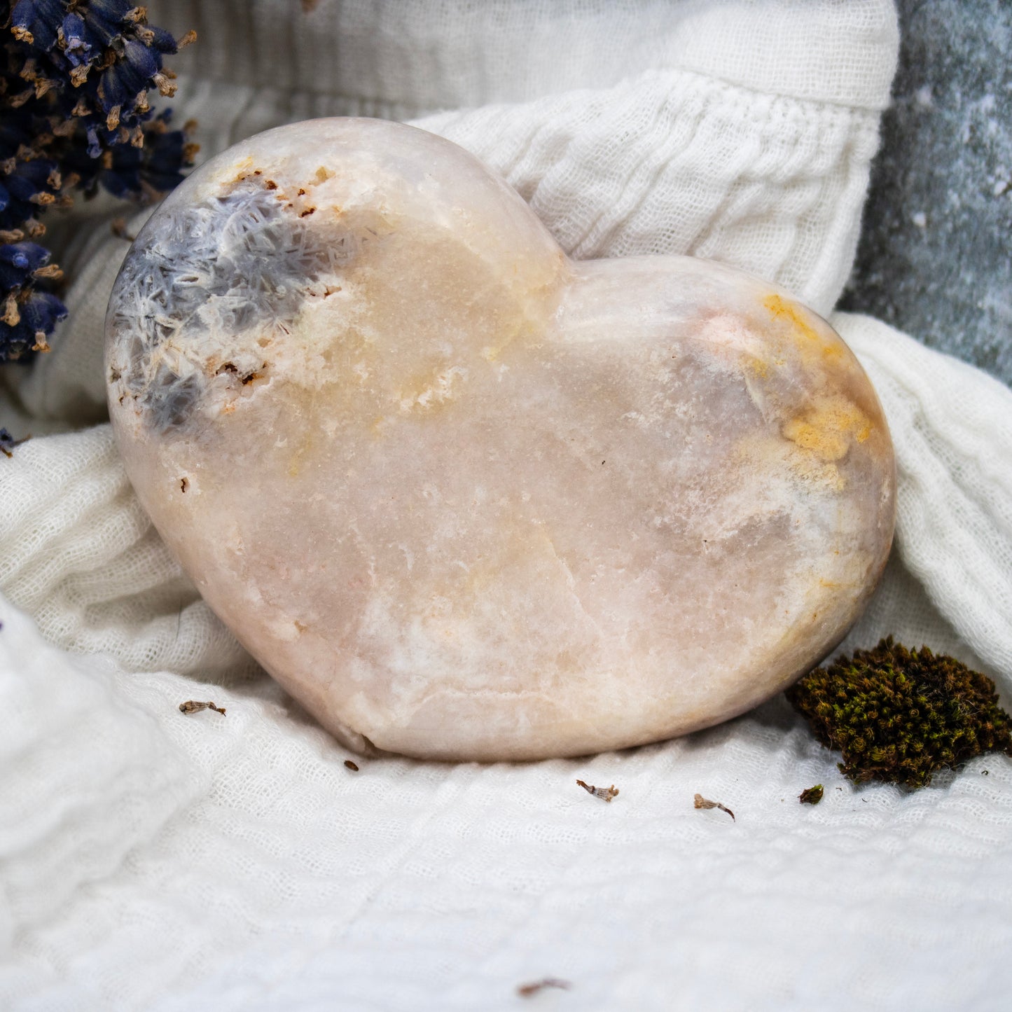 Round stone on a textured white surface with blurred background
