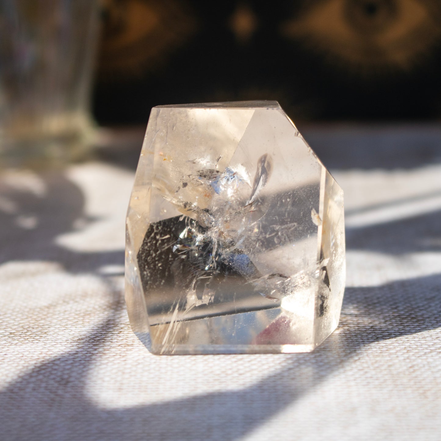 Clear crystal on a textured surface with a blurred background