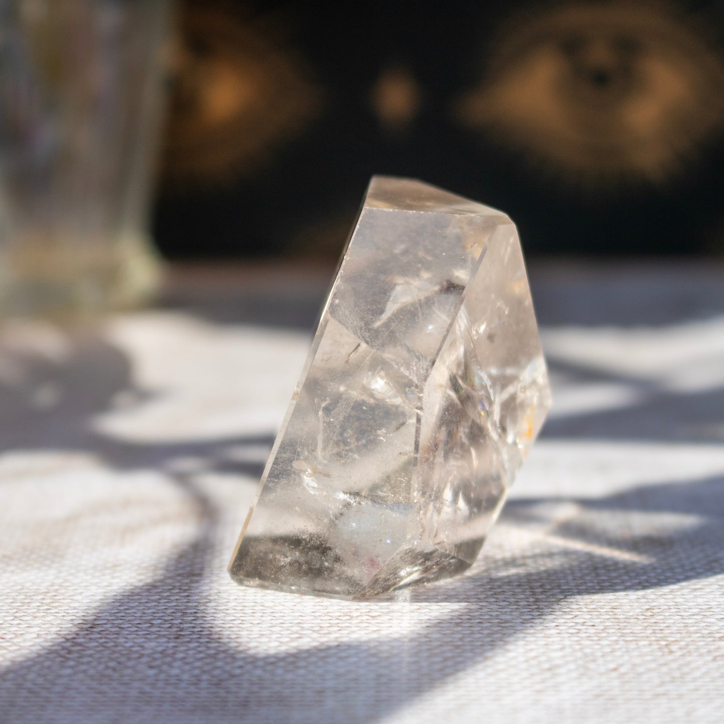 Clear stone on a wooden surface with flowers and a blurred background
