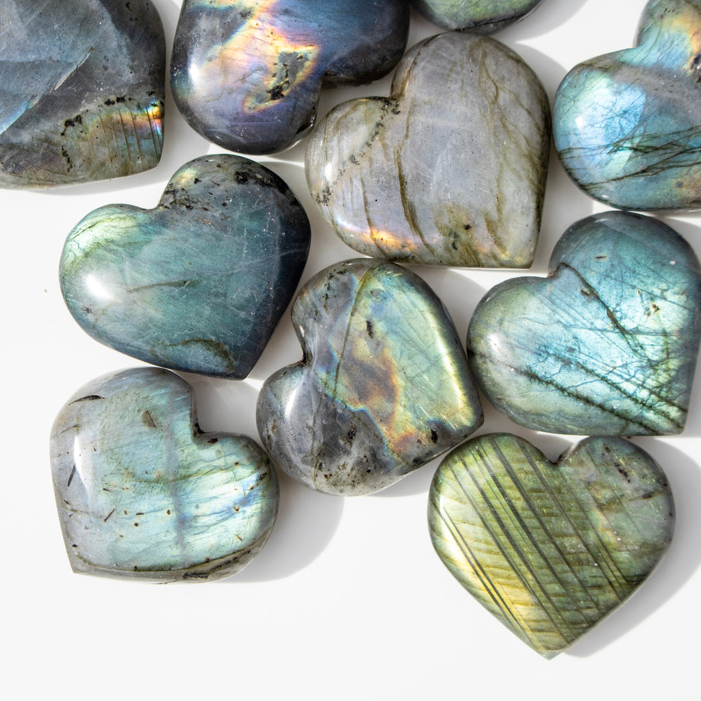Heart-shaped labradorite stones on a white background