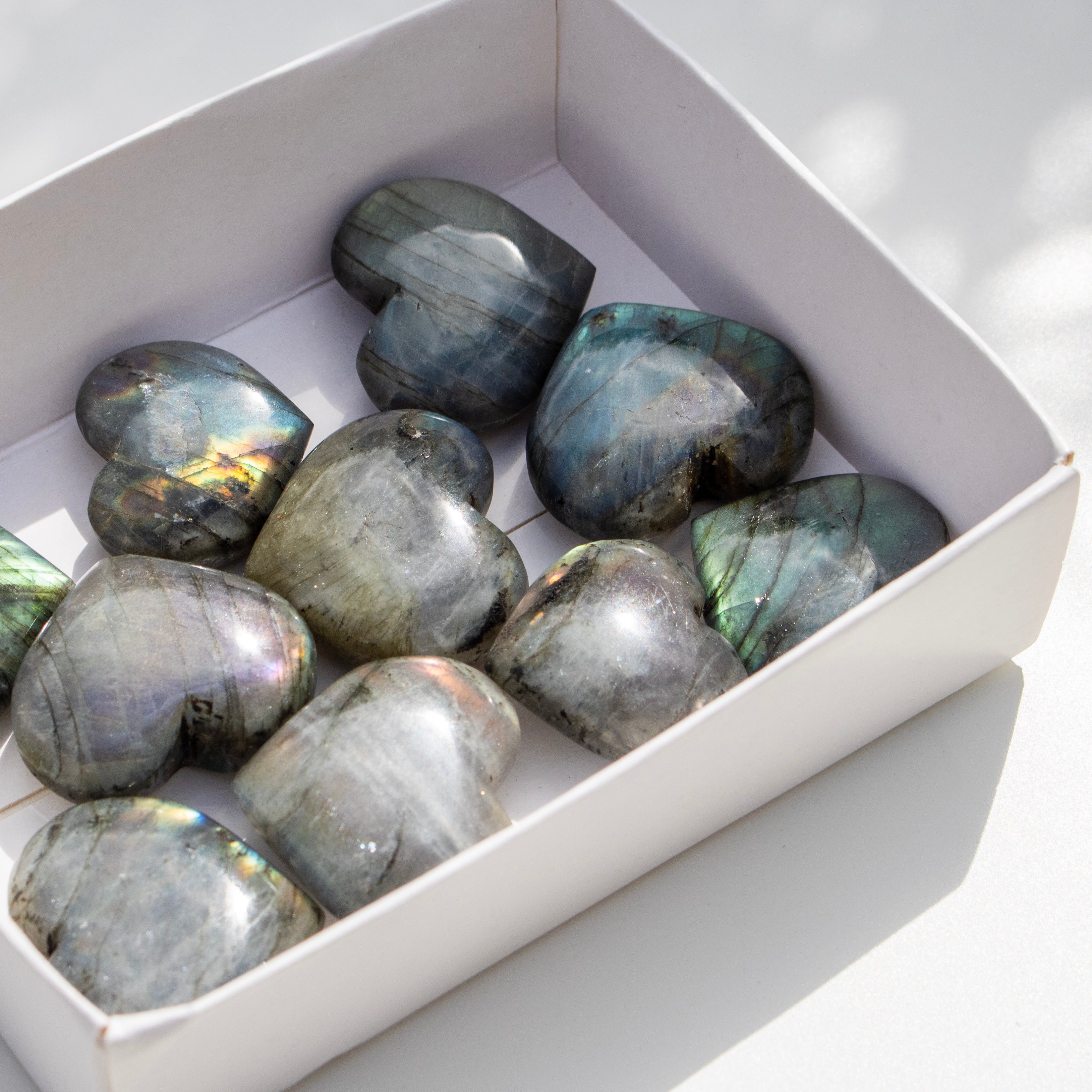 Box of Labradorite stones on a white background
