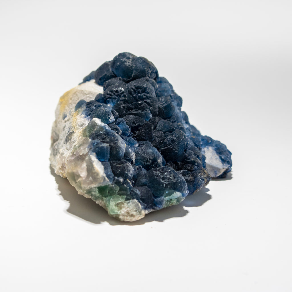 Mineral sample with blue and white colors on a light gray background