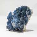 Blue mineral cluster on a white background