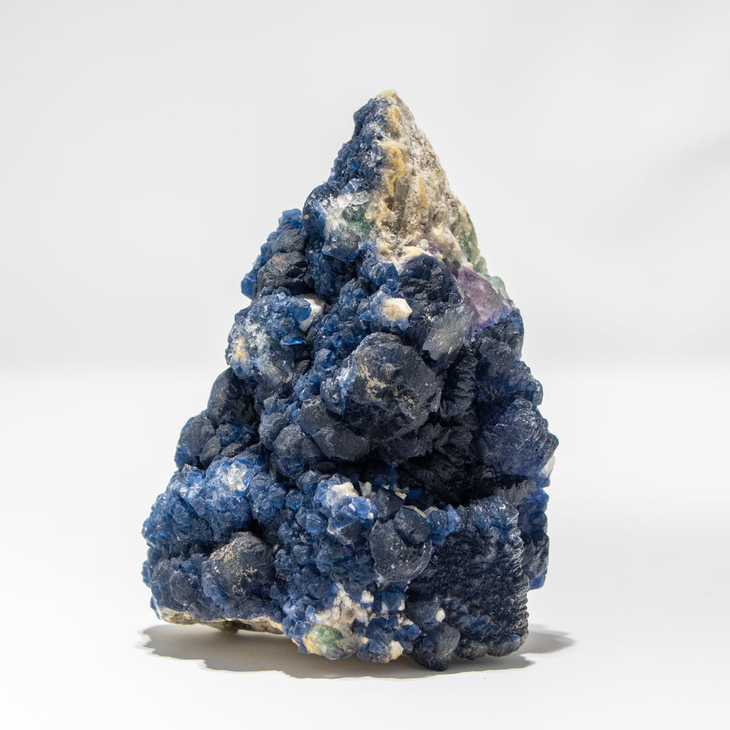 Blue mineral cluster on a white background