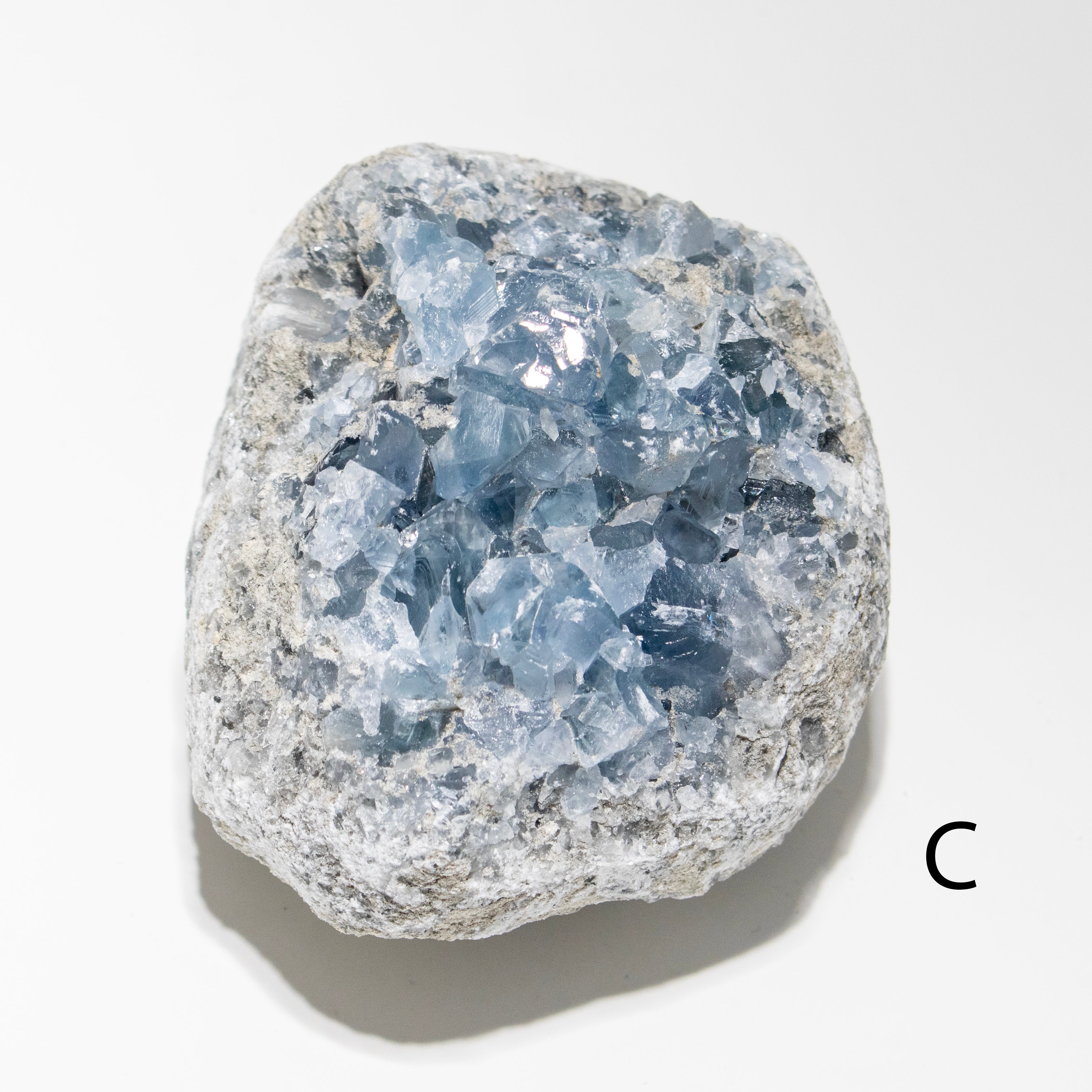 Crystal rock with blue and gray hues on a white background