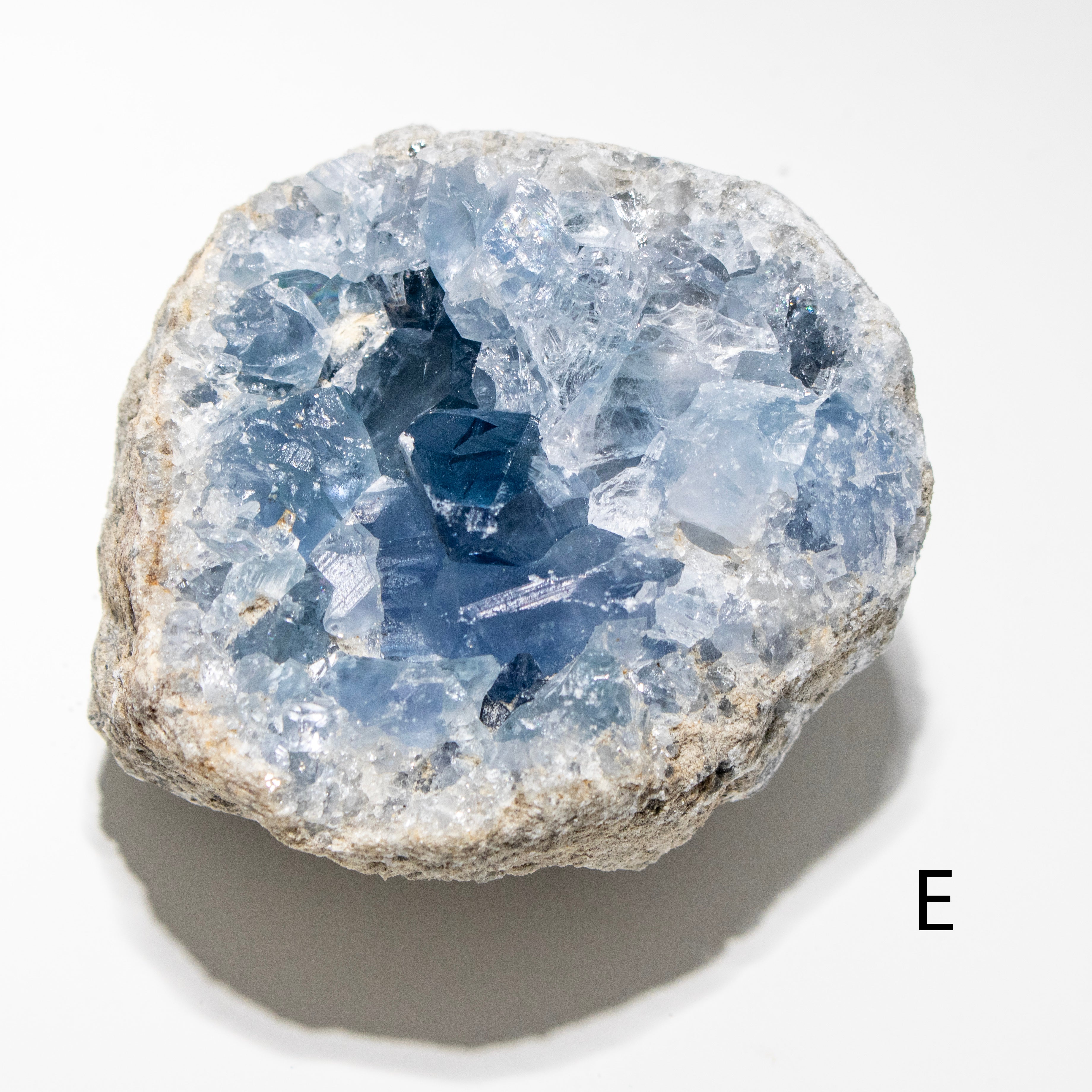 Geode with blue crystals on a white background