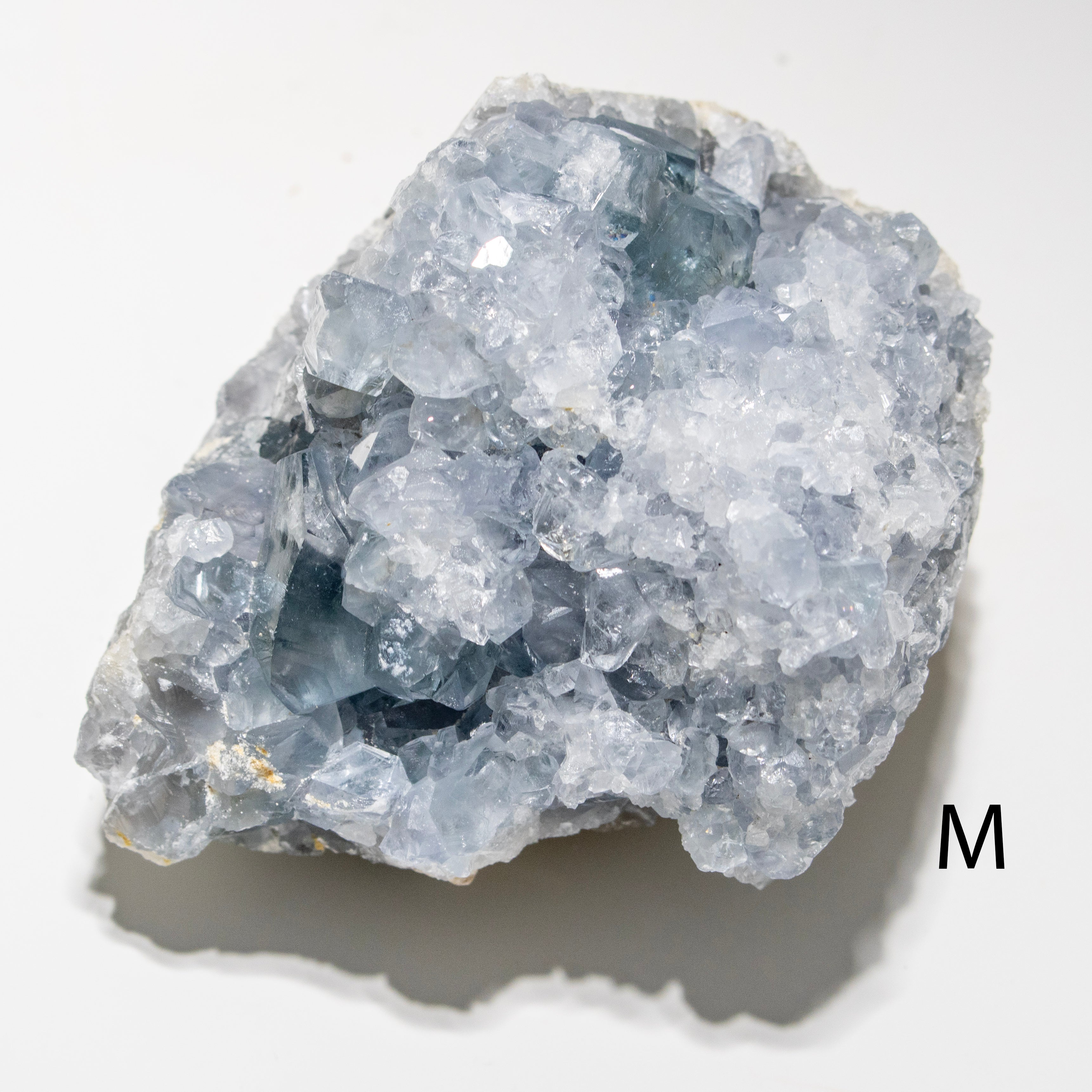 Mineral sample with crystal structure on a white background