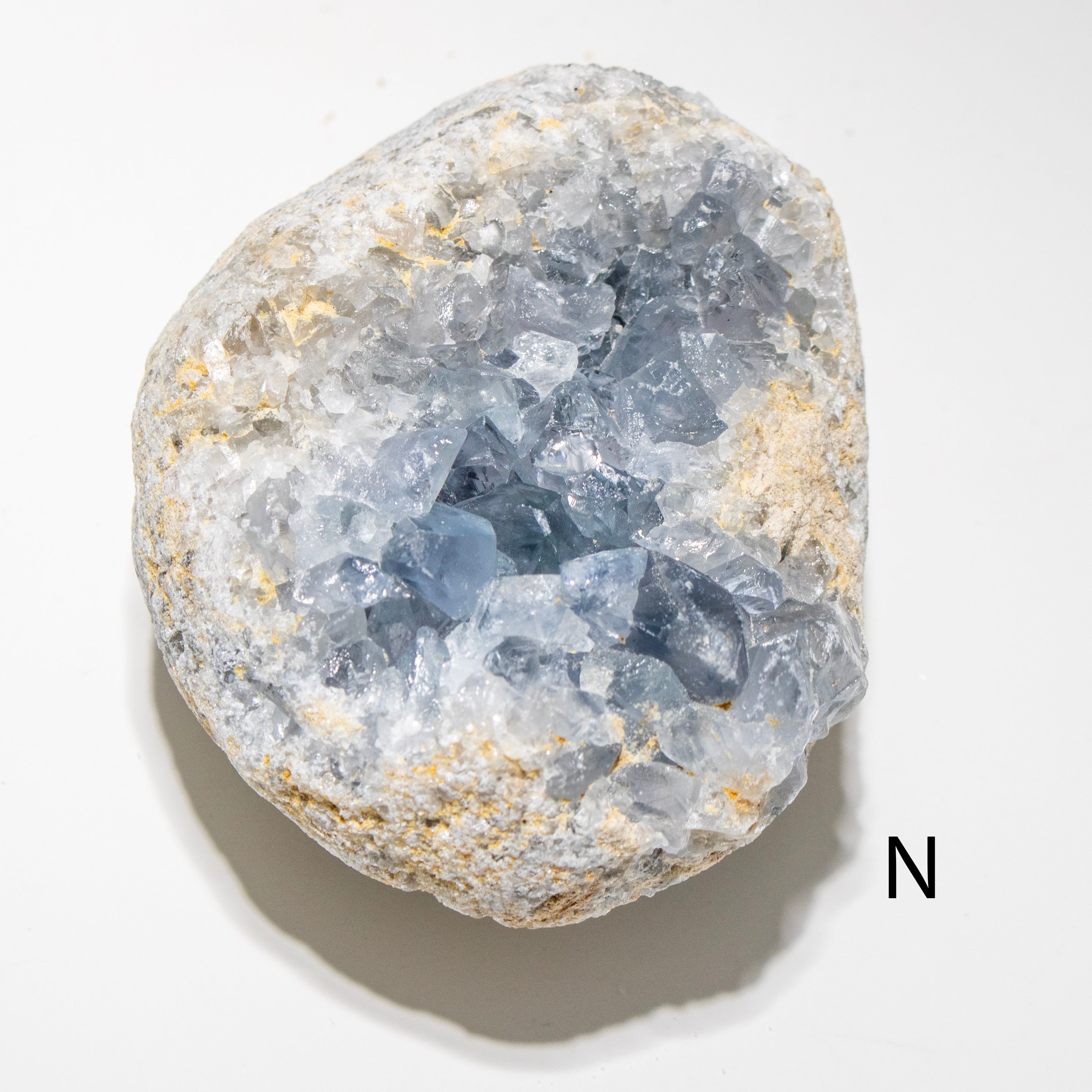 Crystal geode with visible internal structure on a white background