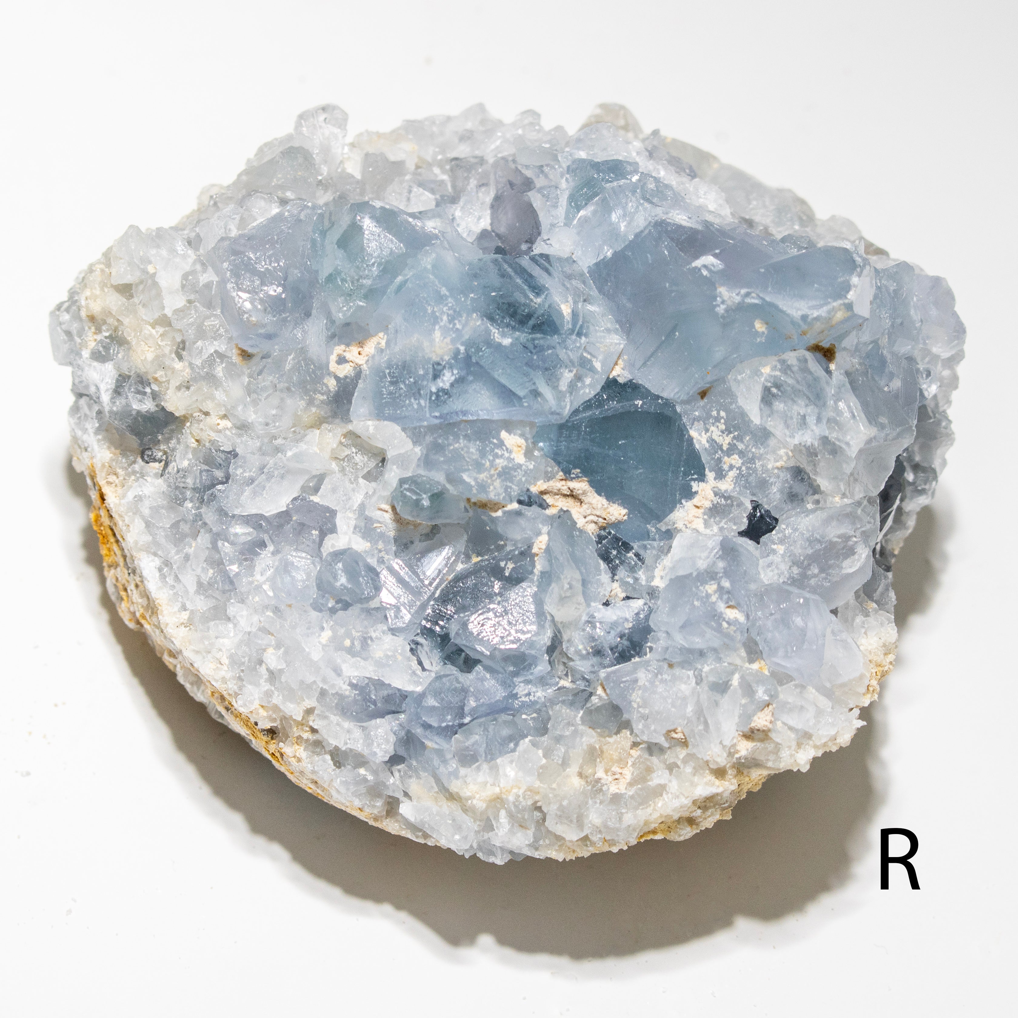 Crystal rock with blue and clear crystals on a white background