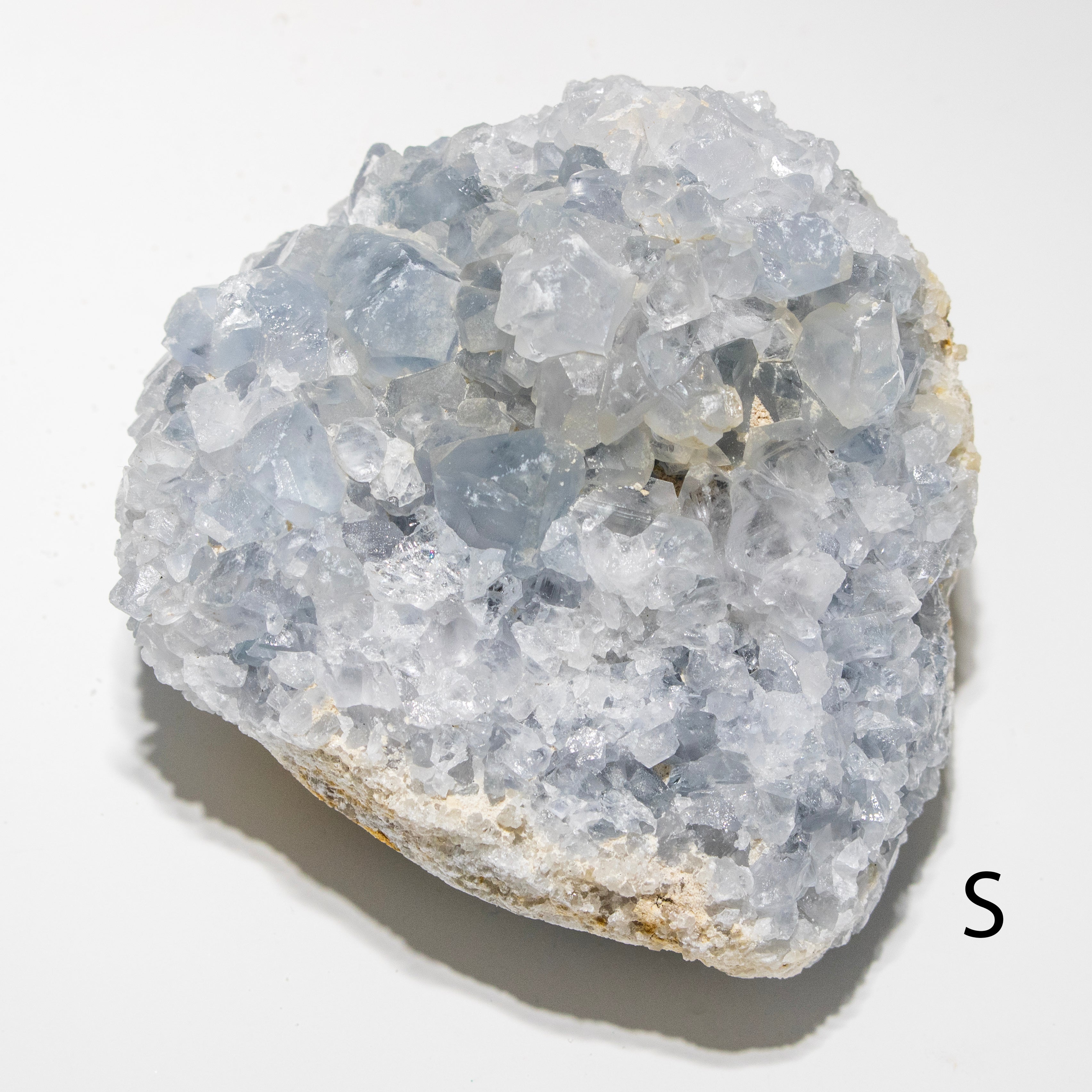 Crystal rock on a white background with a letter 'S' on the side.