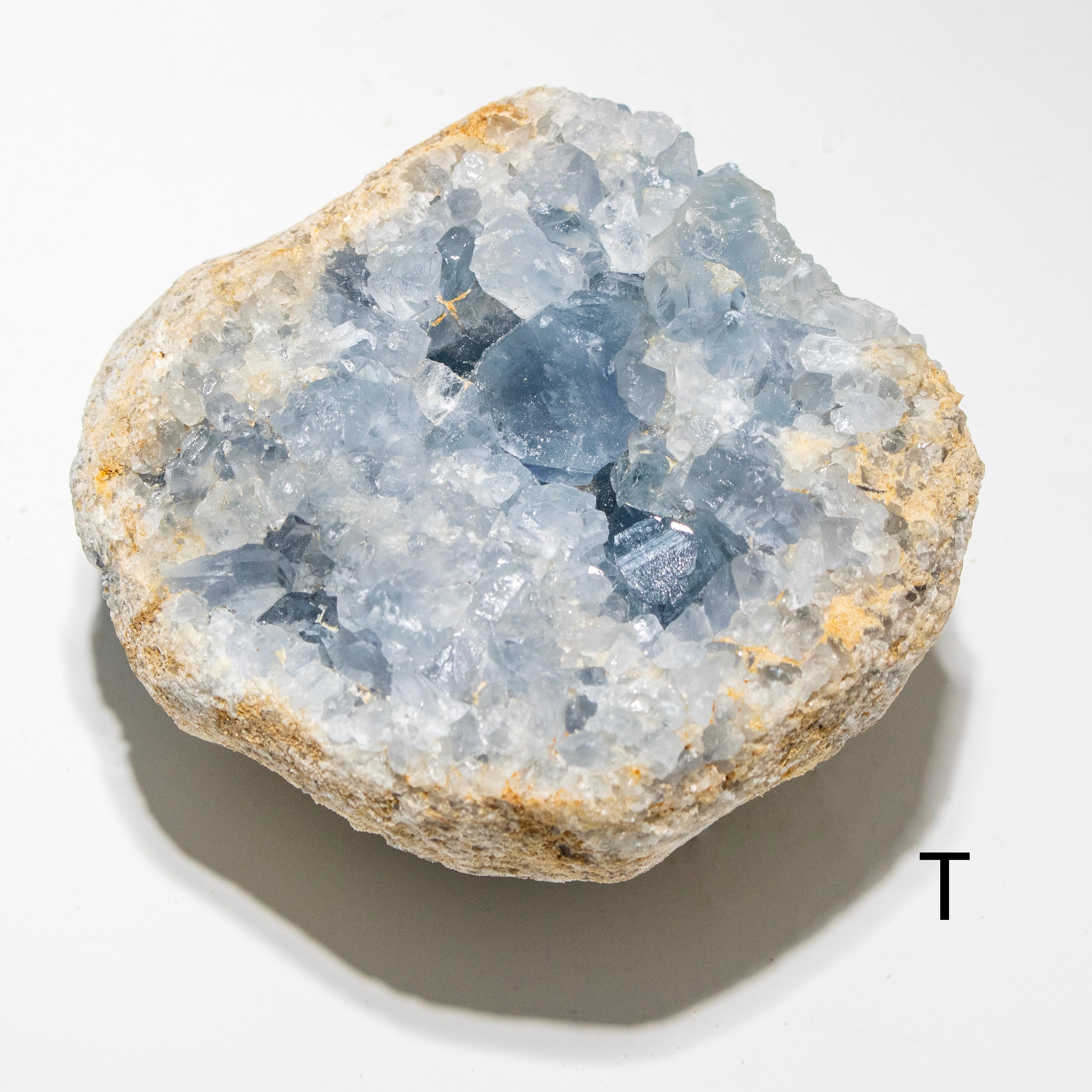 Geode with blue crystals on a white background
