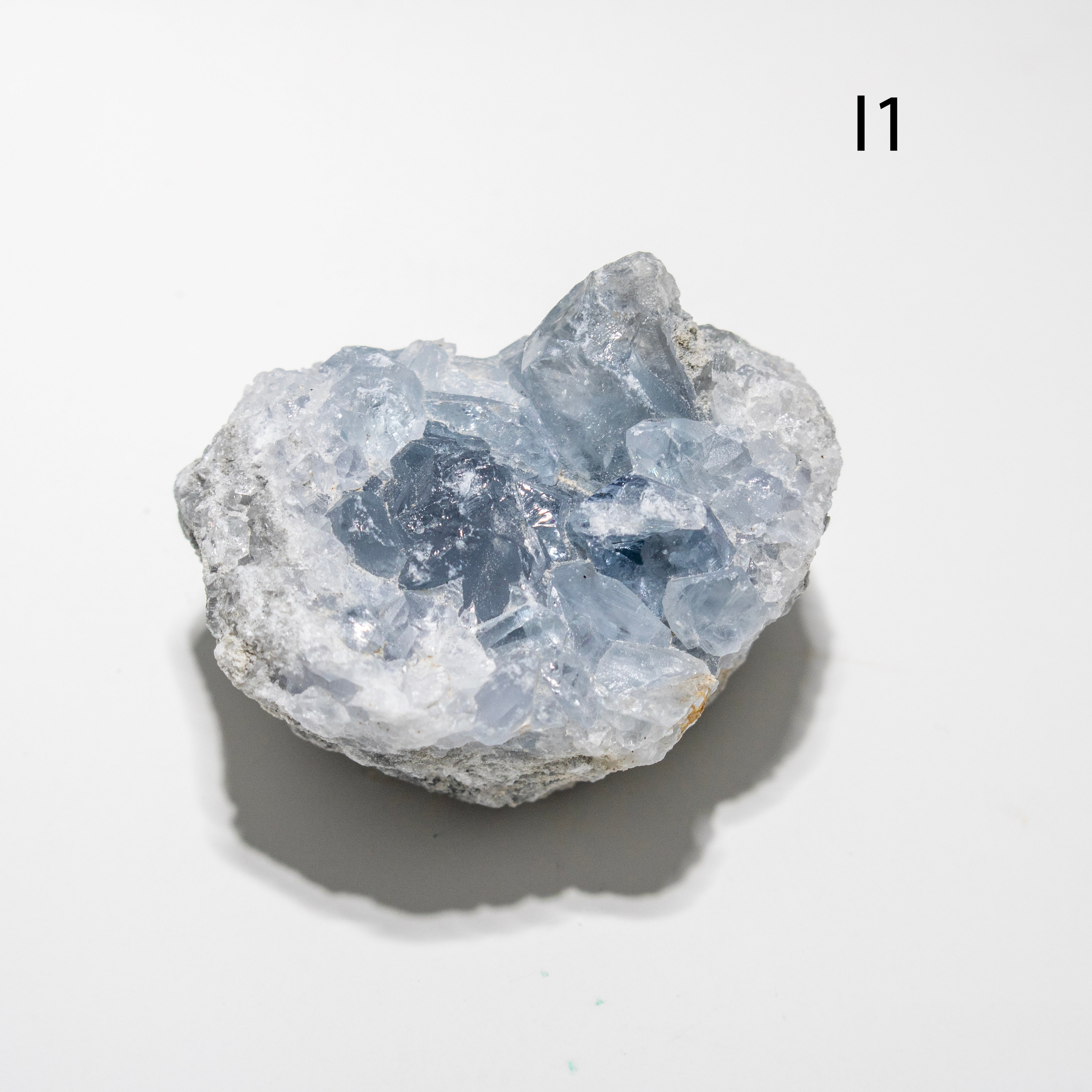 Raw blue crystal on a white background