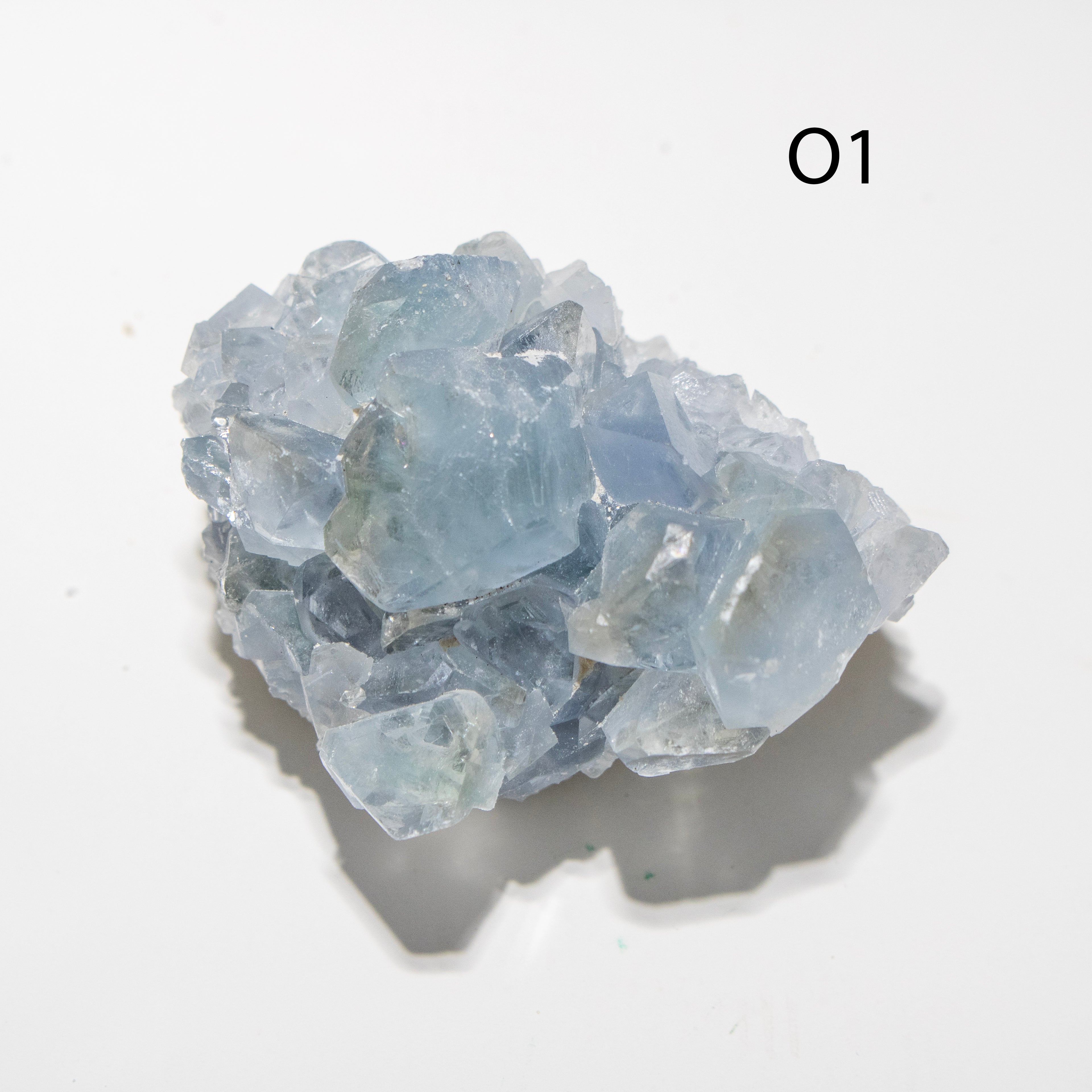Blue crystal cluster on a white background with '01' label