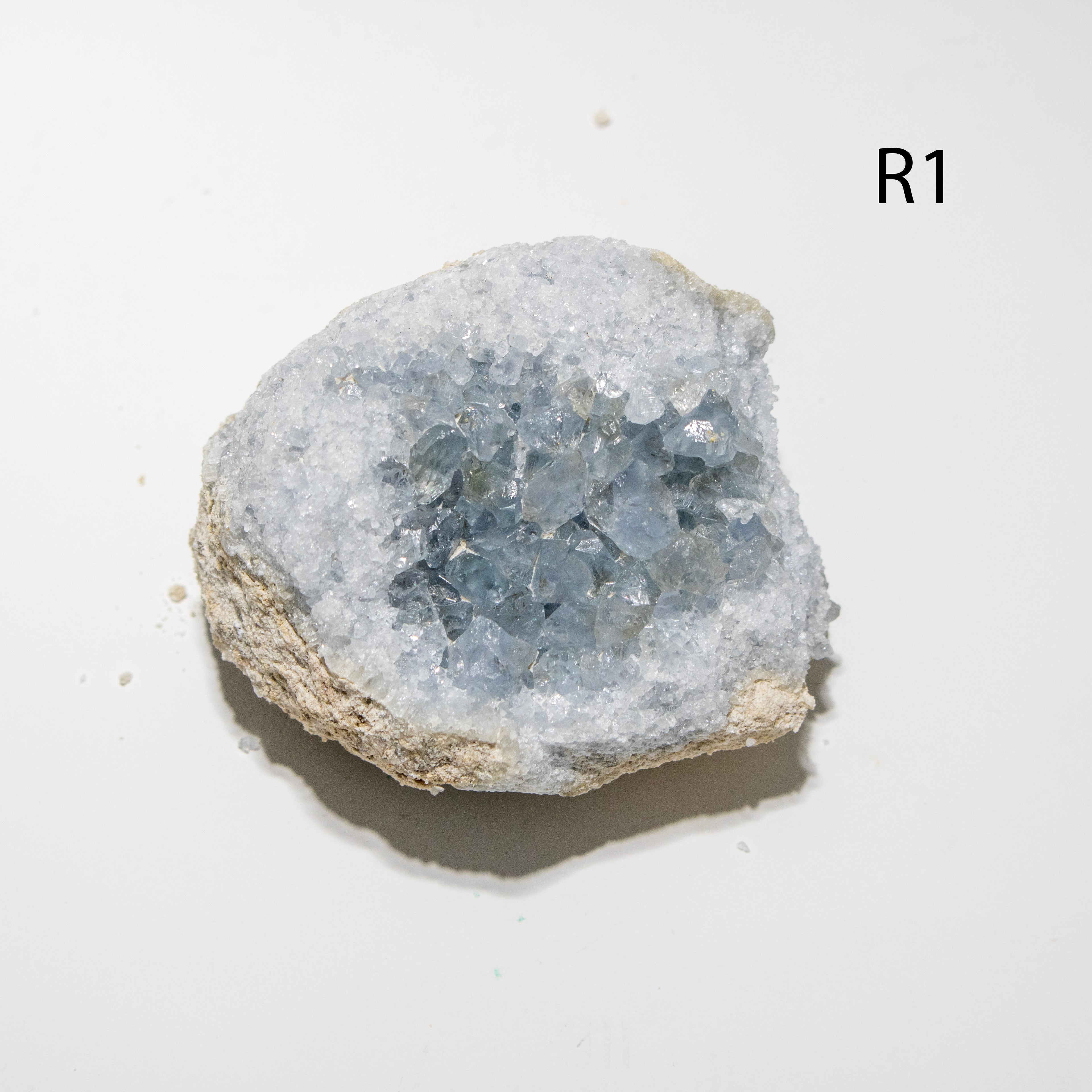 Mineral sample with crystal formation on a white background