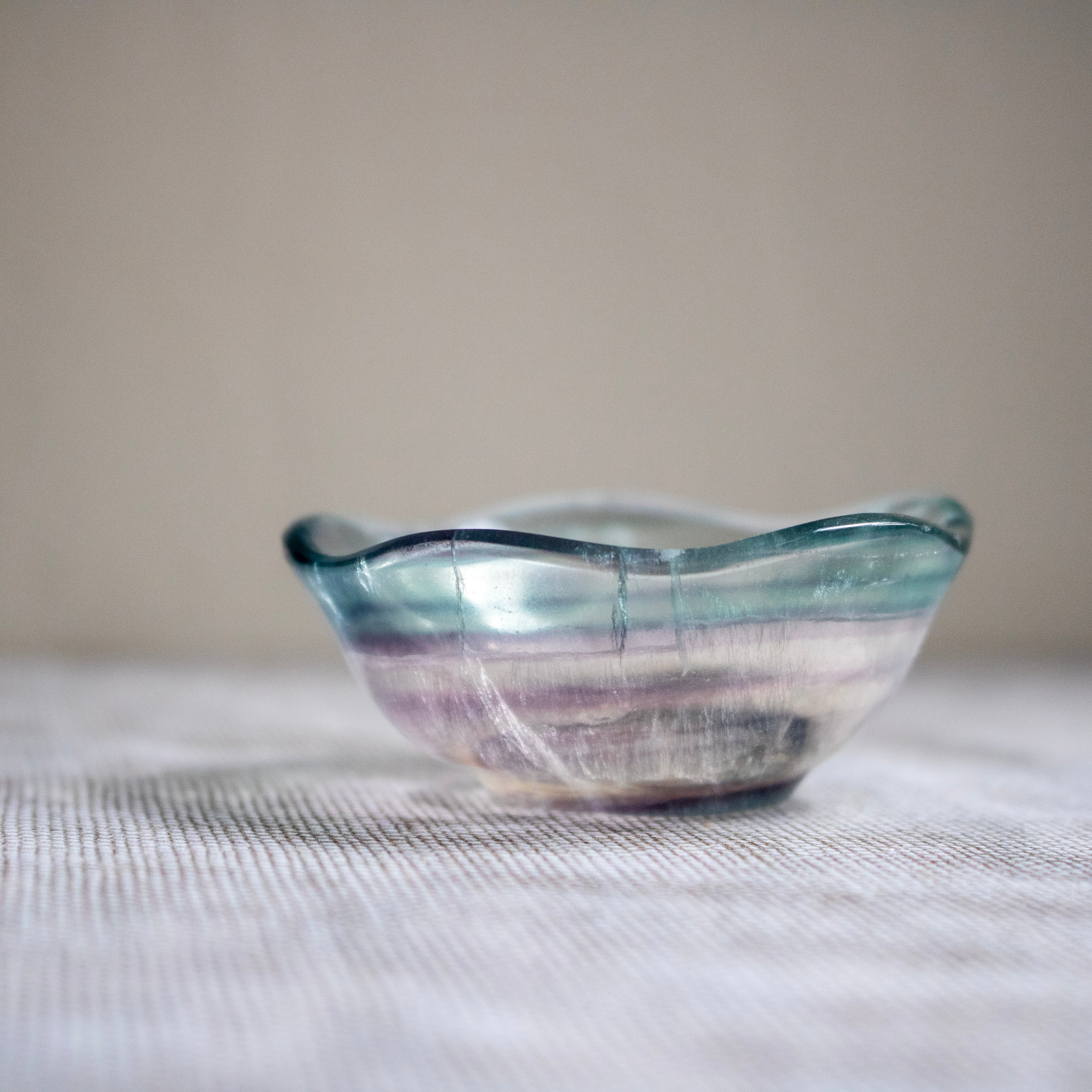Crystal bowl with wavy design on a textured surface