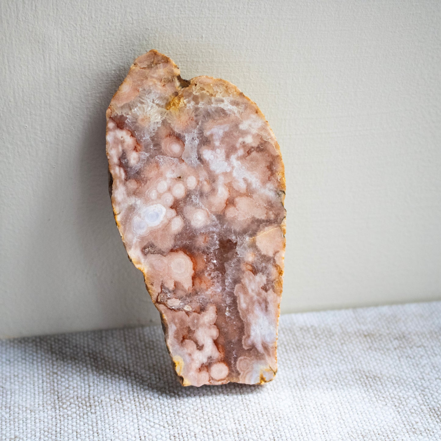 Geode slice on a textured surface with a neutral background