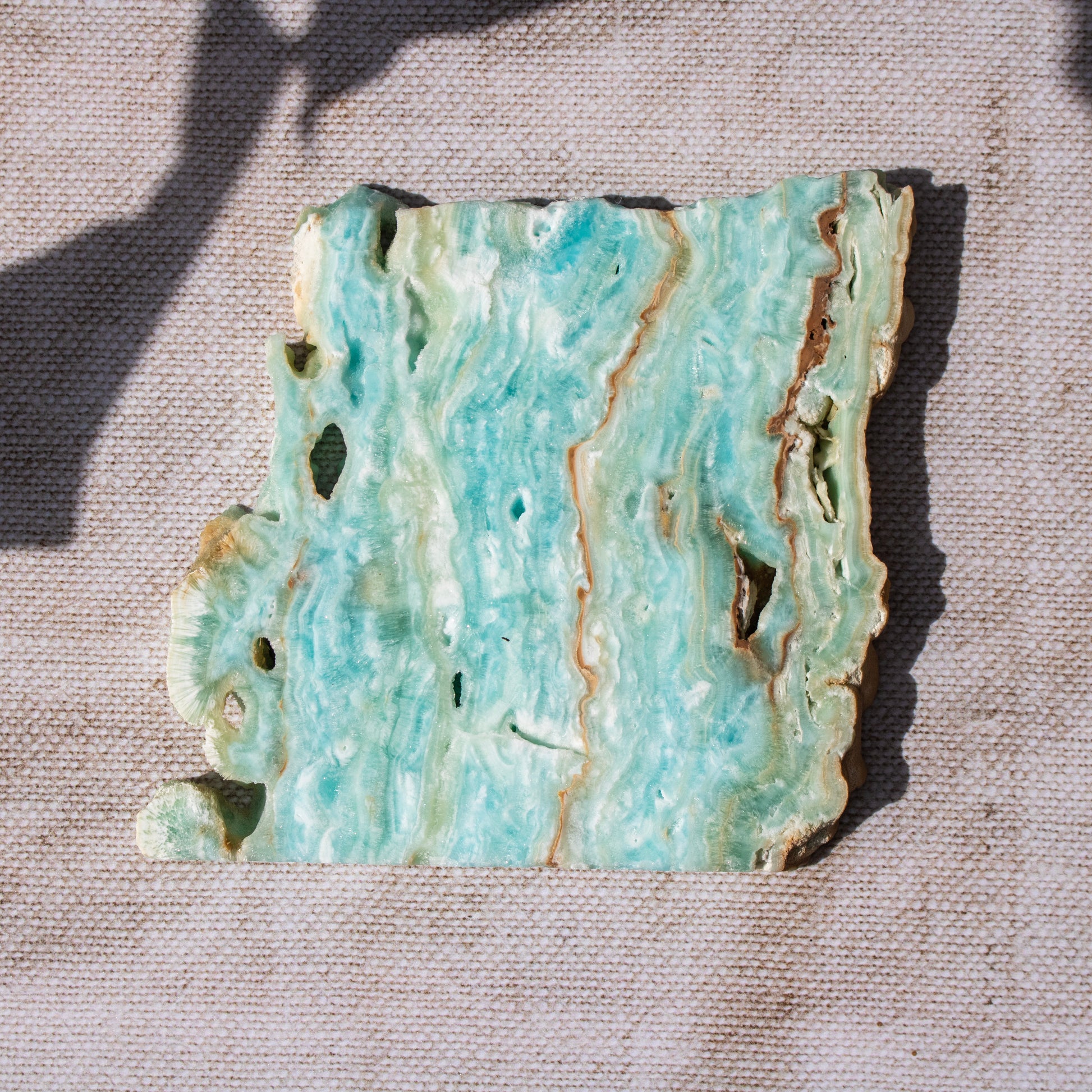 Decorative crystal piece with a textured surface on a textured beige background