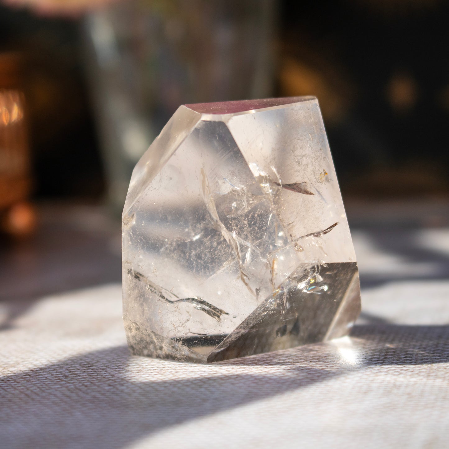 Clear crystal on a textured surface with a blurred background