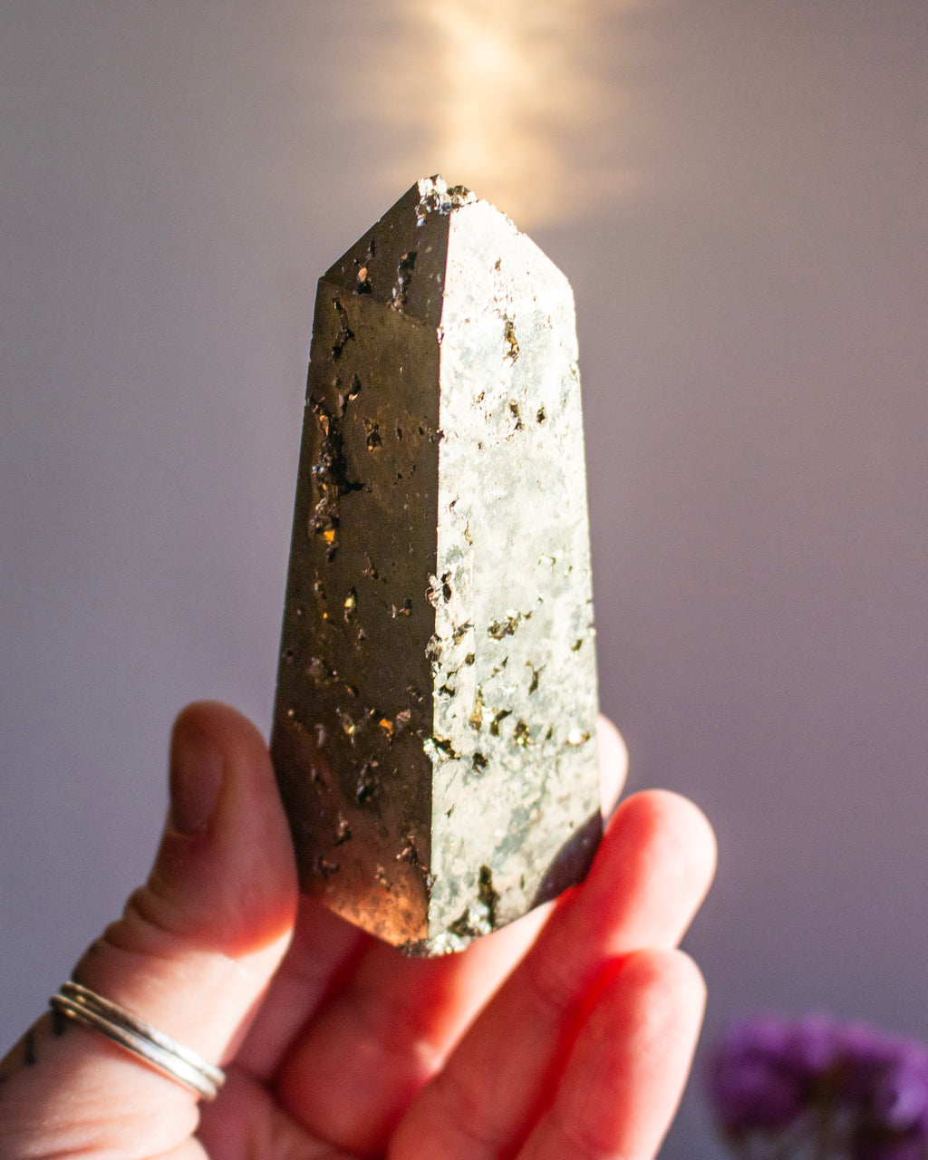 Person holding a crystal with a blurred background