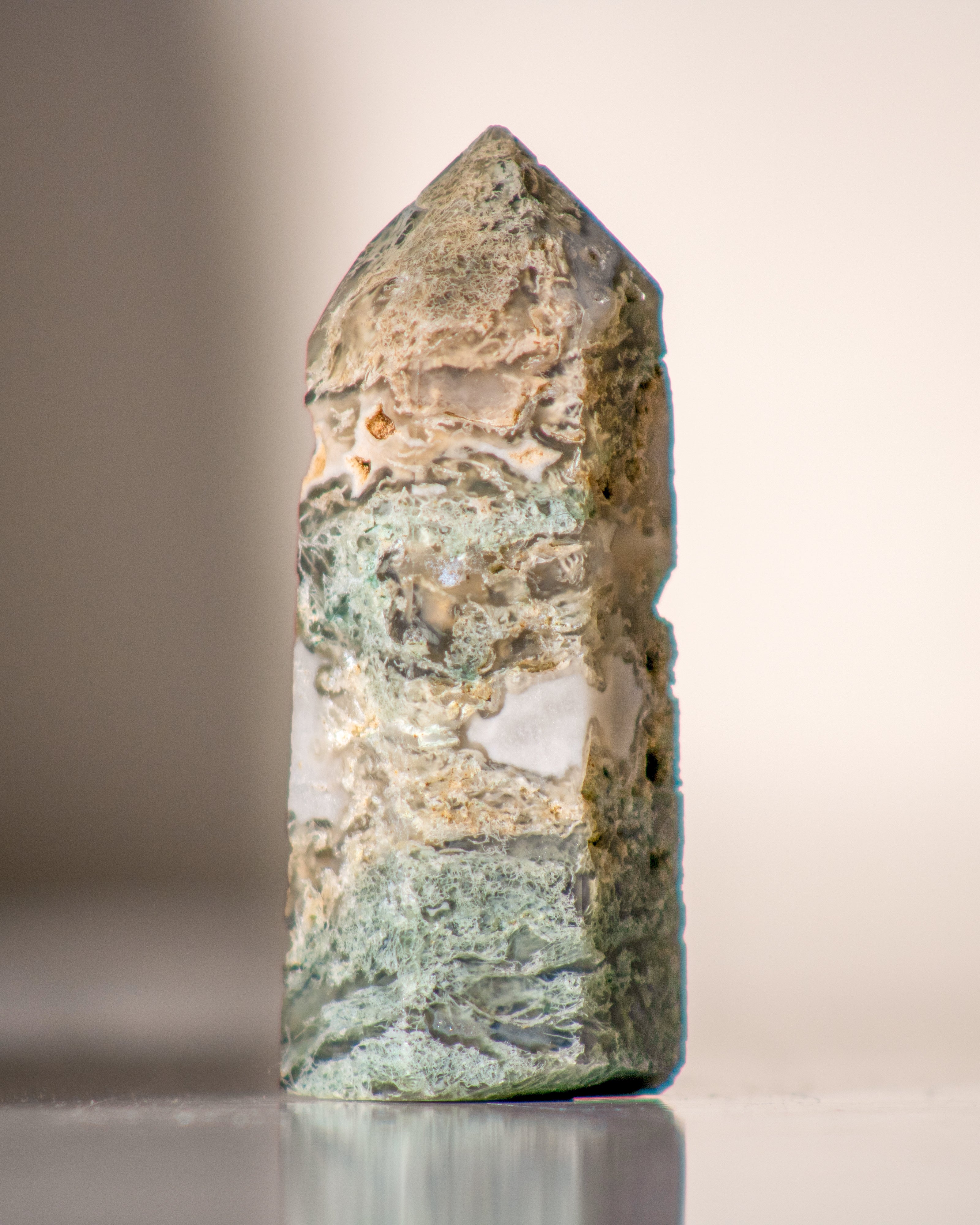 Decorative crystal with a natural pattern on a reflective surface