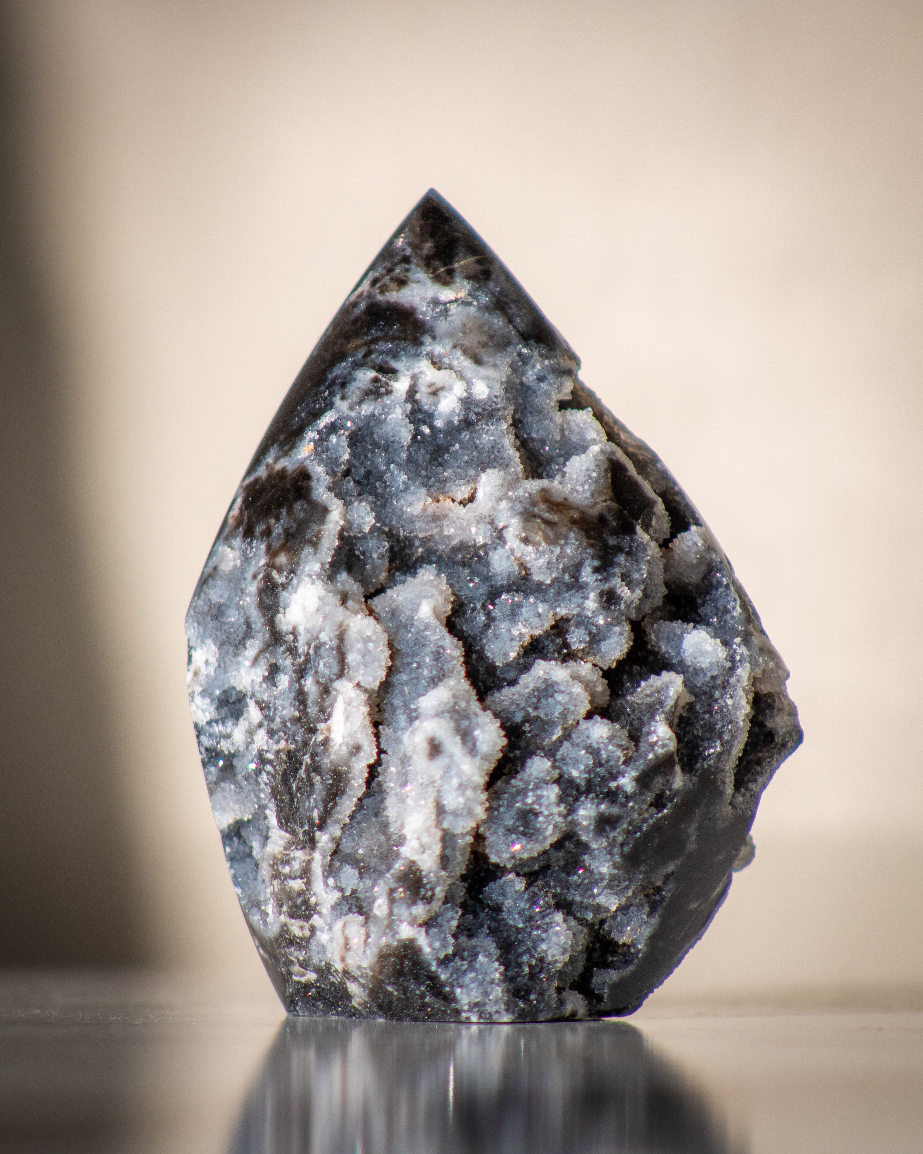 Geode crystal with a reflective surface on a blurred background