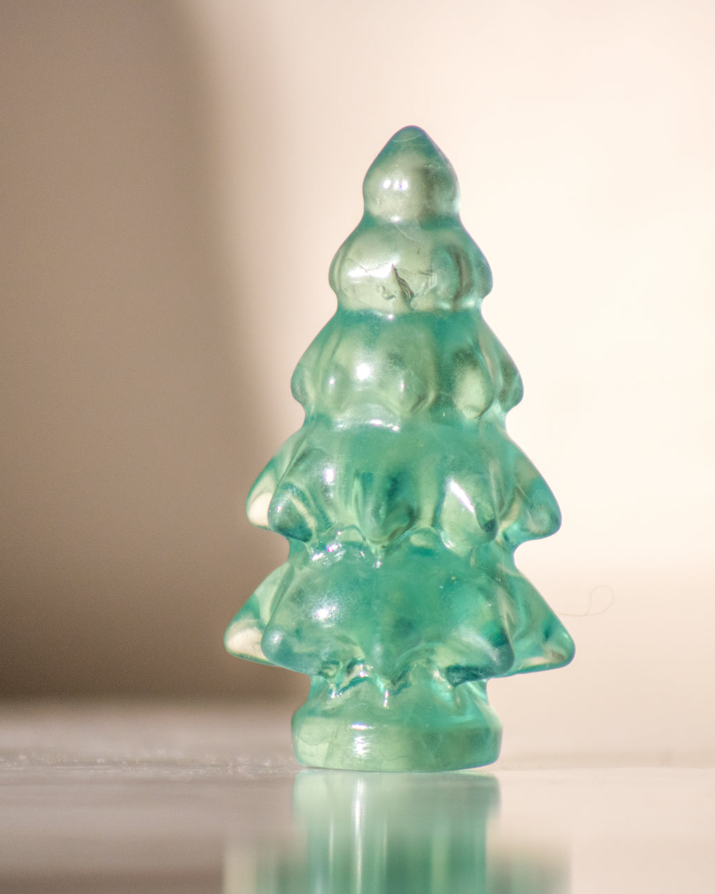 a green pine tree shaped crystal