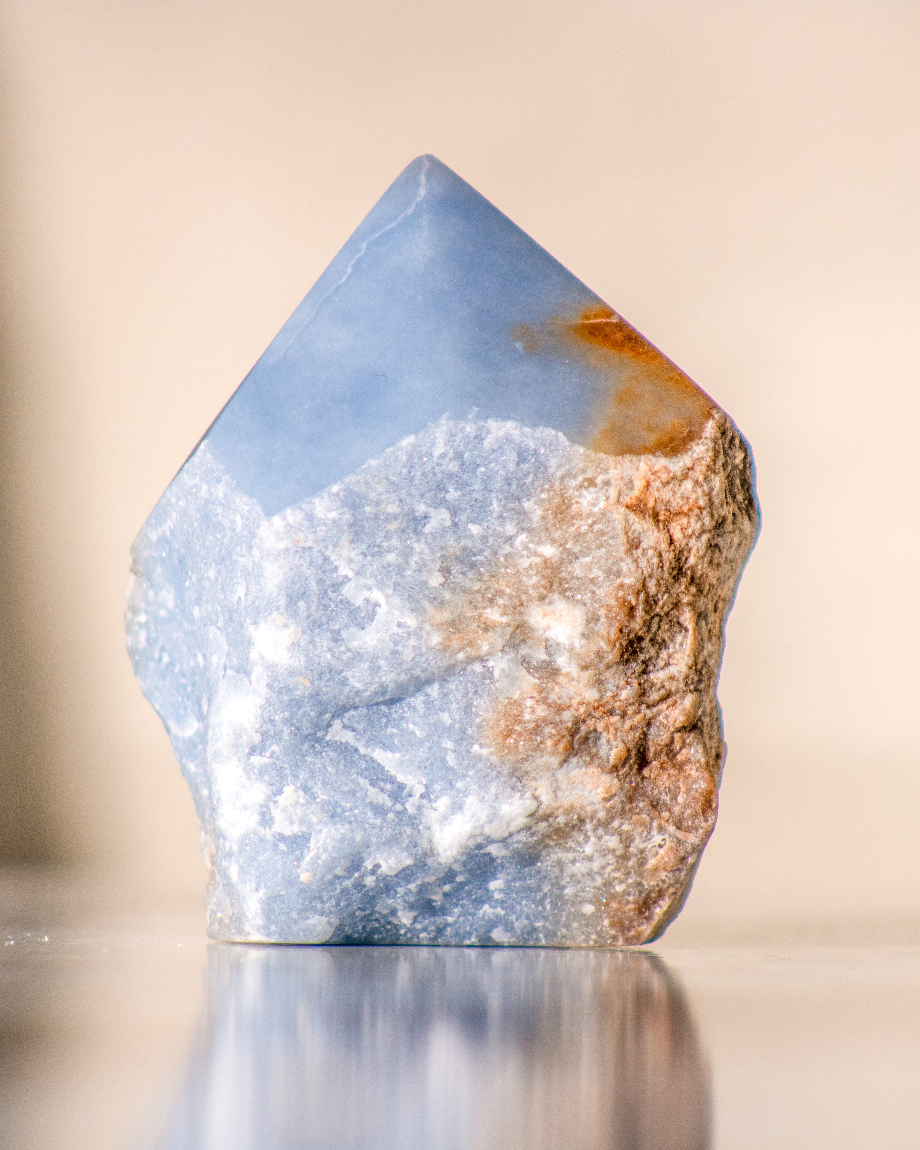 a rough blue stone with the top polished into a point