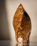 a brown twisting polished stone with beige splotches all over it