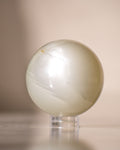a white ball on a small clear plastic stand