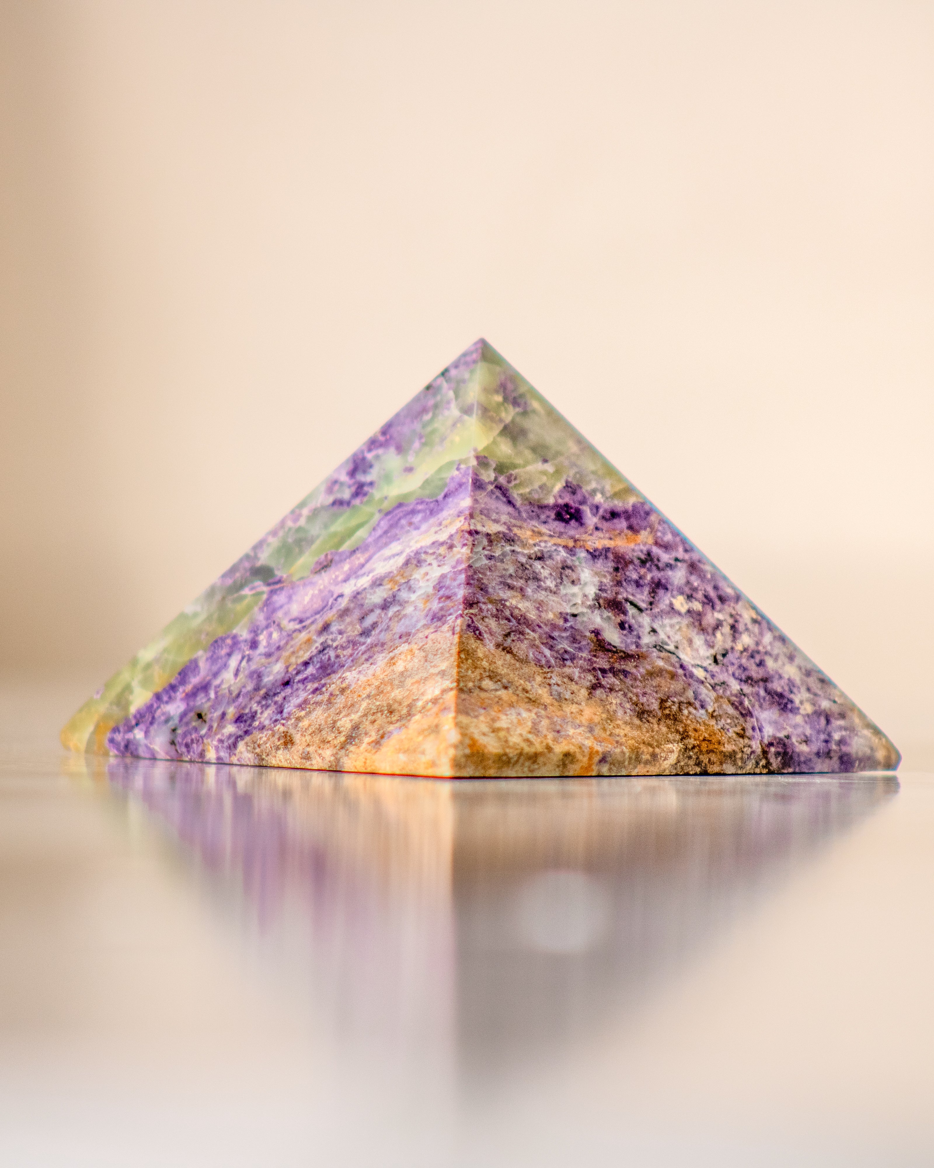 a purple and green crystal pyramid