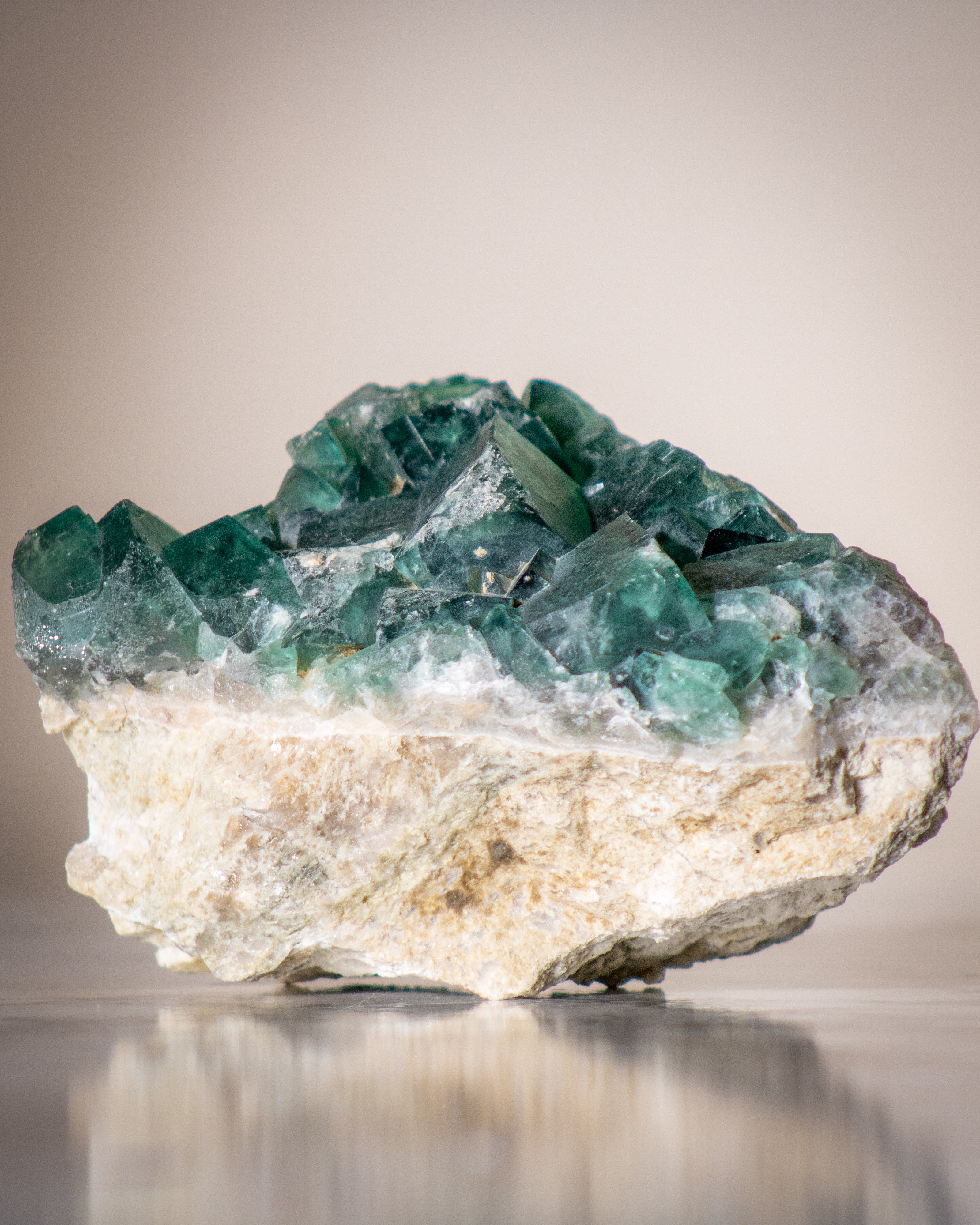 a large rough stone with a green cubic top and beige bottom half