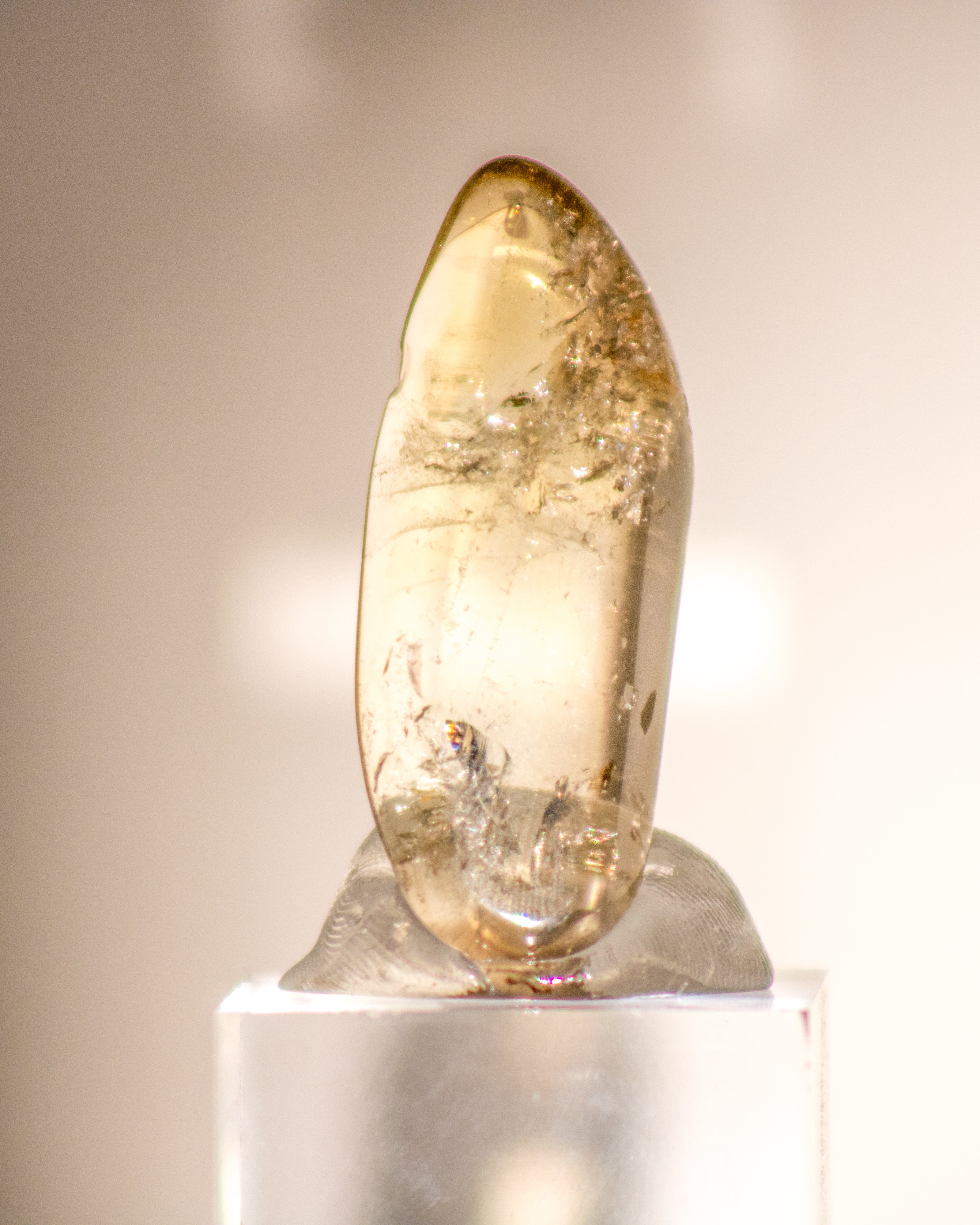 a clear citrine tumblestone with a golden glow