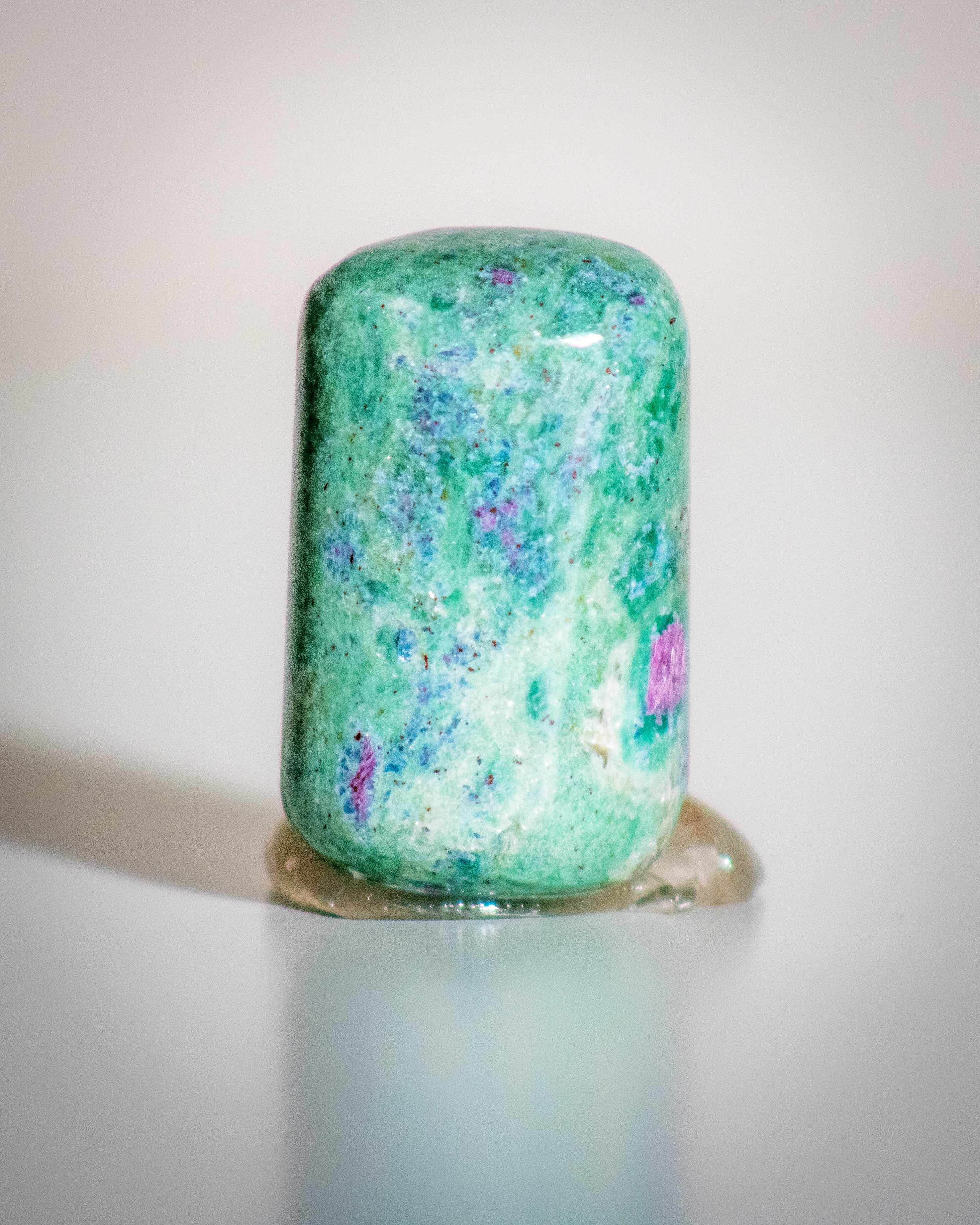 a speckled green, blue and pink stone