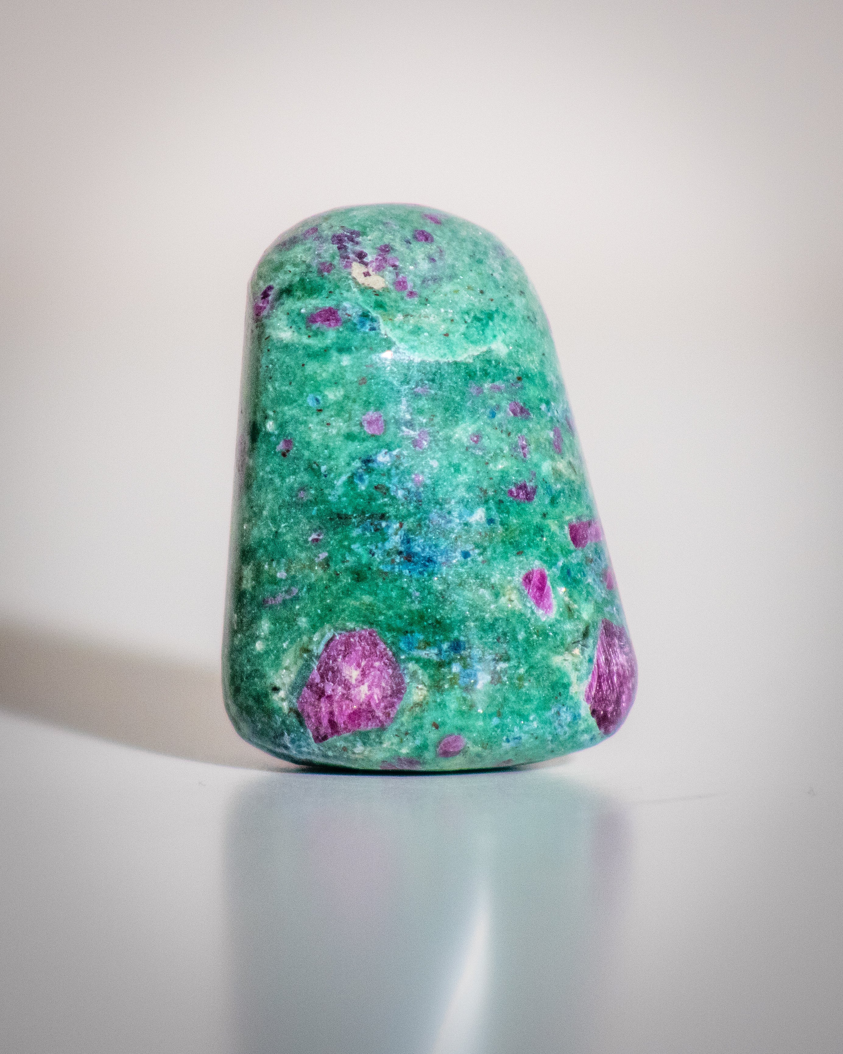 a speckled green, blue and pink stone