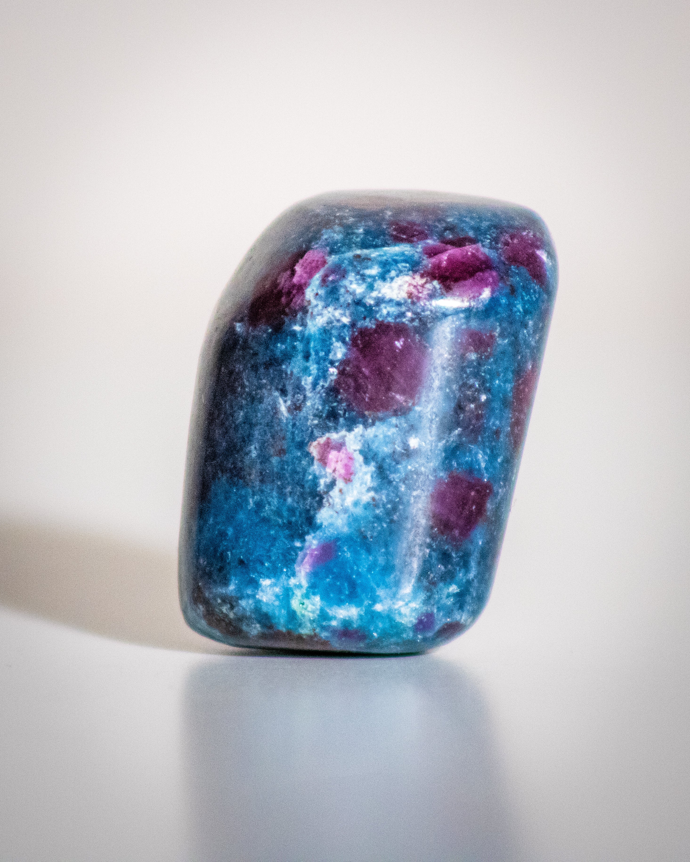 Blue and purple stone on a light gray background