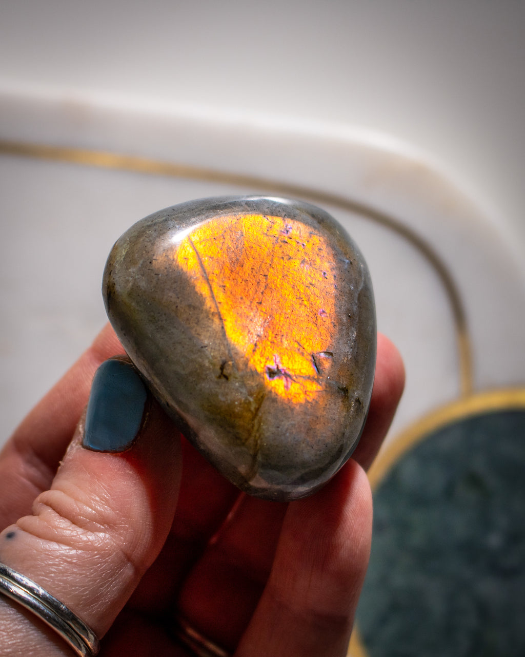 Hand holding a glowing stone with a blurred background