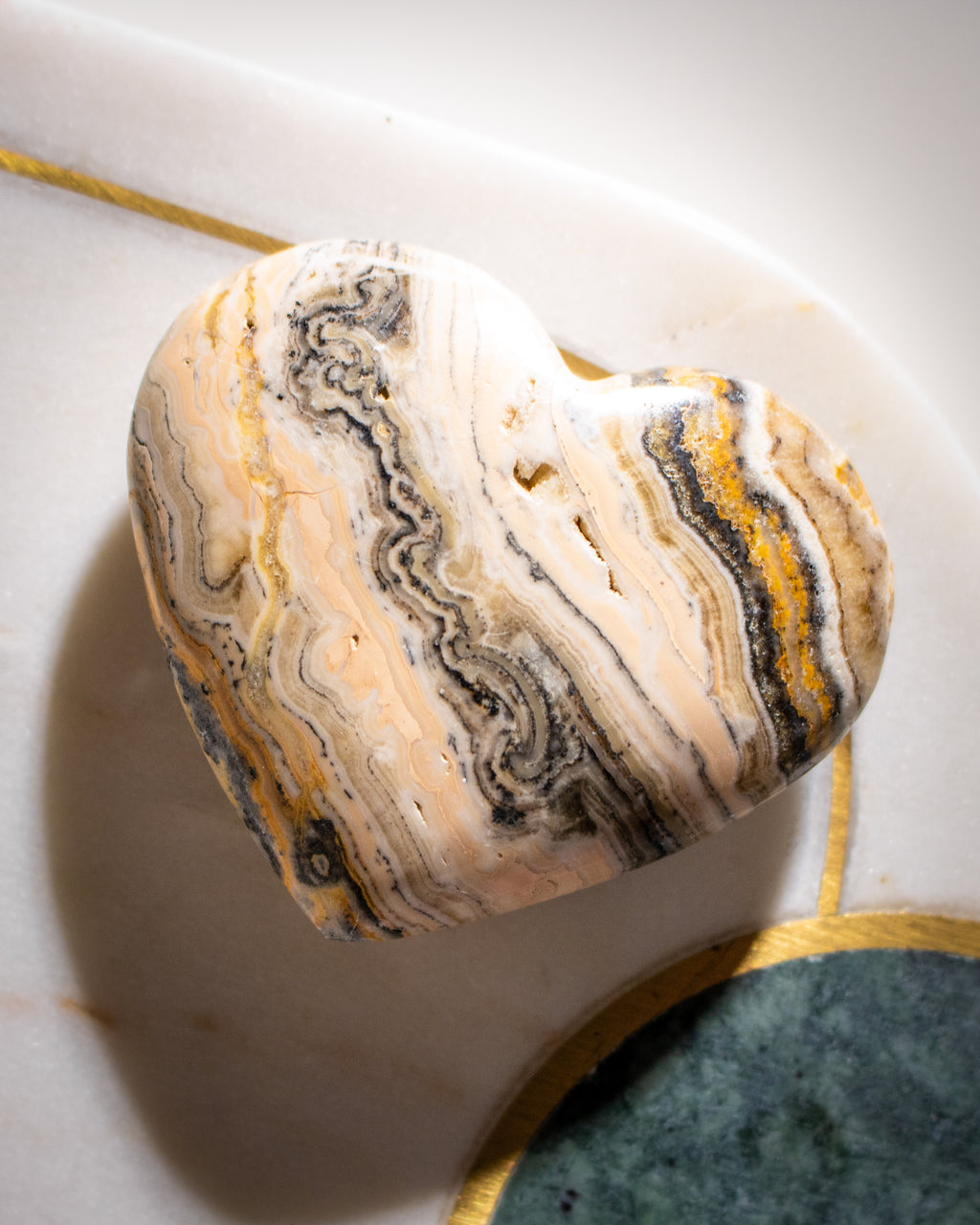 Marble-like stone with swirling patterns on a light background