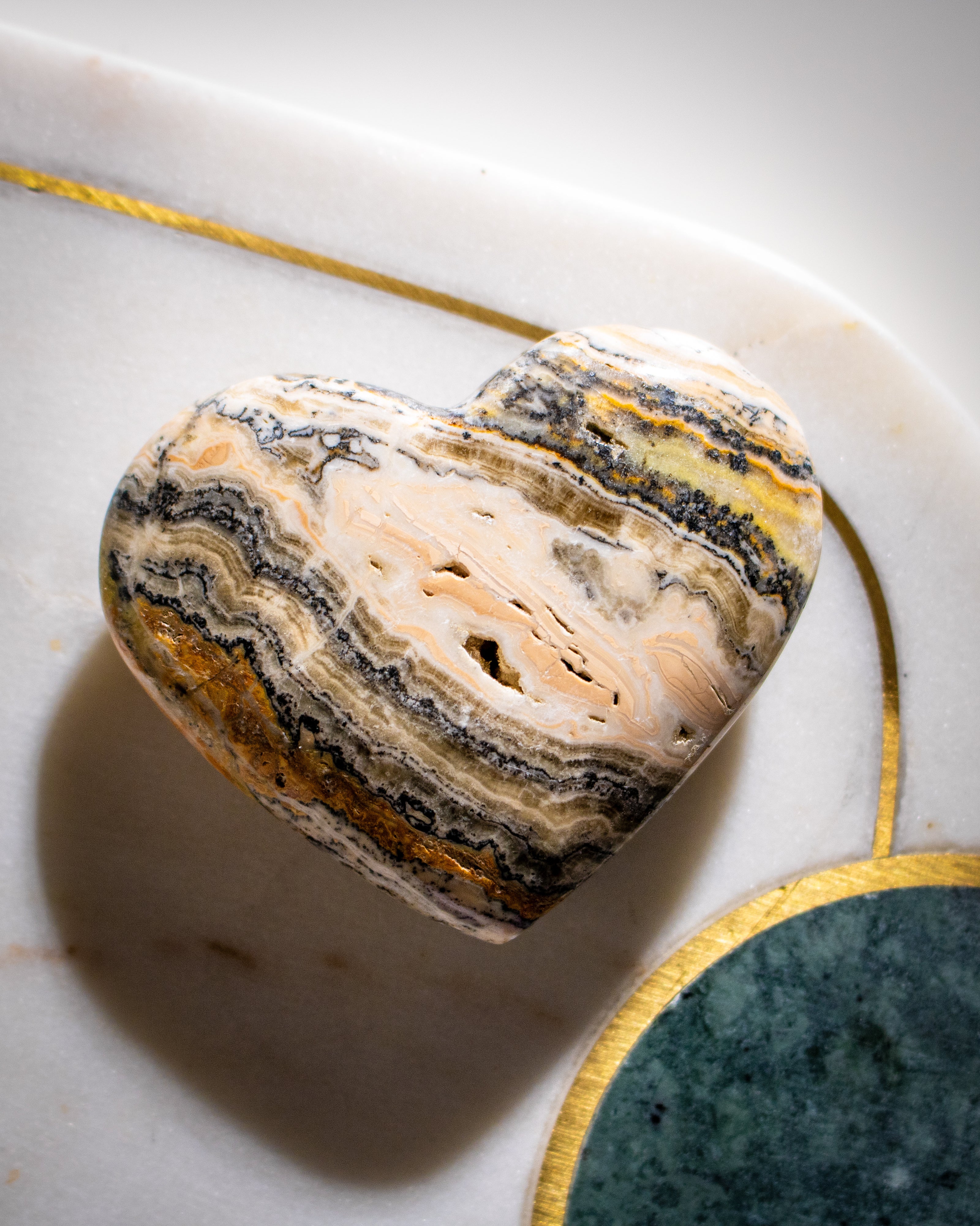 Marble-patterned stone on a marble surface with gold accents