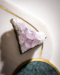 a small triangular pale purple amethyst cluster crystal looking top down, with a white background