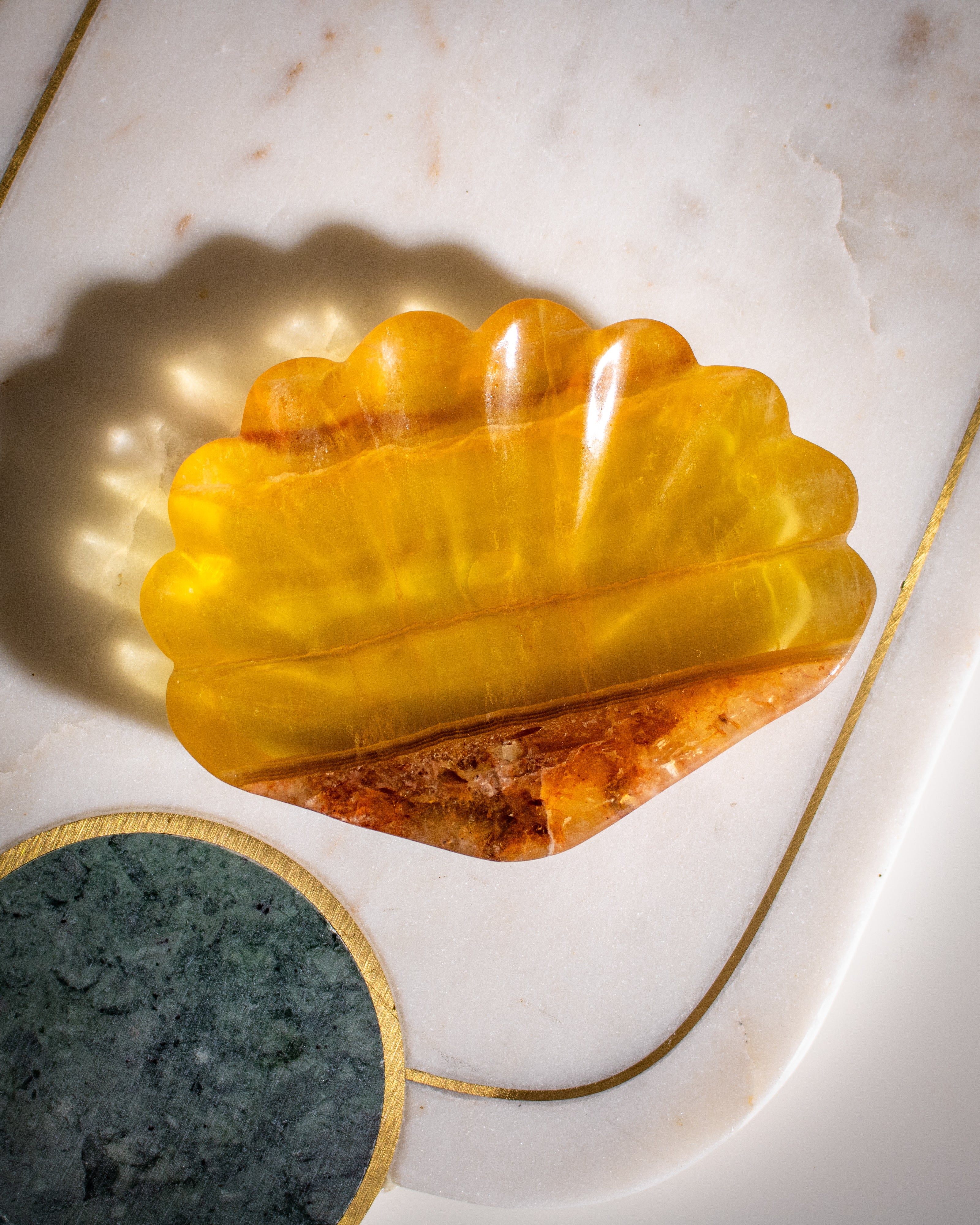 Yellow stone dish on a marble surface