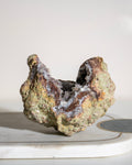 a large geode crystal on a plain background