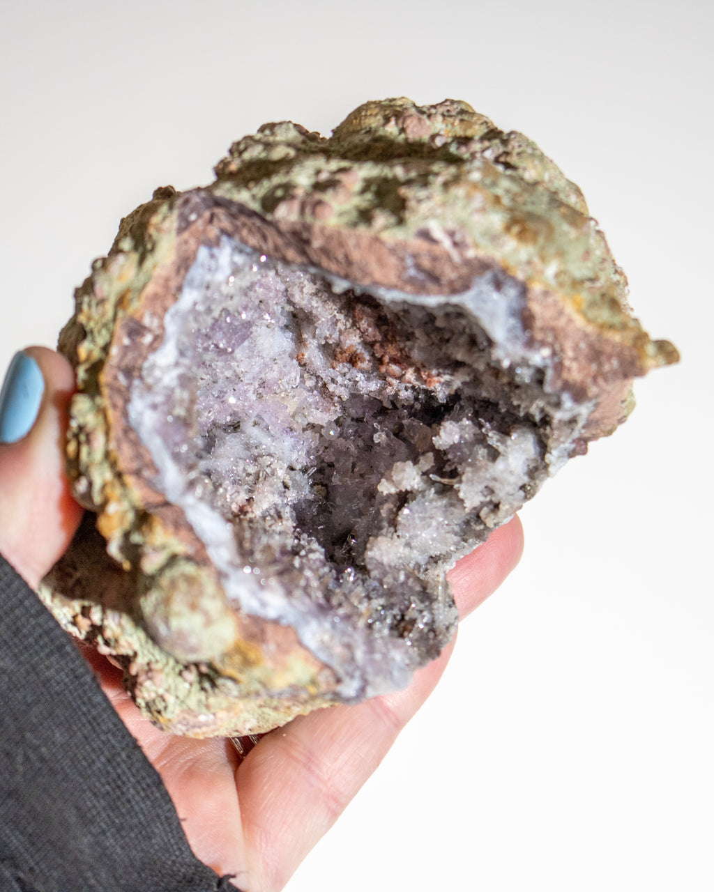 a crystal geode being held in the hand