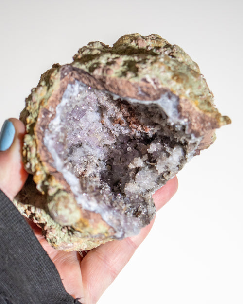 a crystal geode being held in the hand